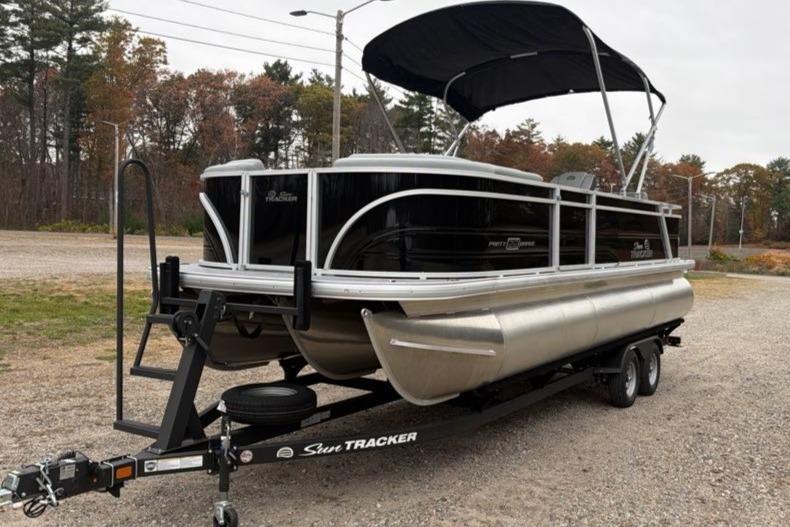 2026 Sun Tracker Party Barge 22 RF XP3 pontoon boat on trailer, parked outdoors.