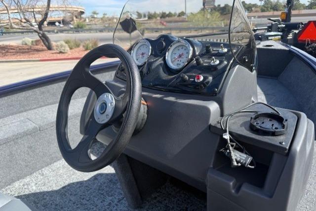 2026 Tracker Super Guide V-16 SC boat dashboard with steering wheel and gauges.