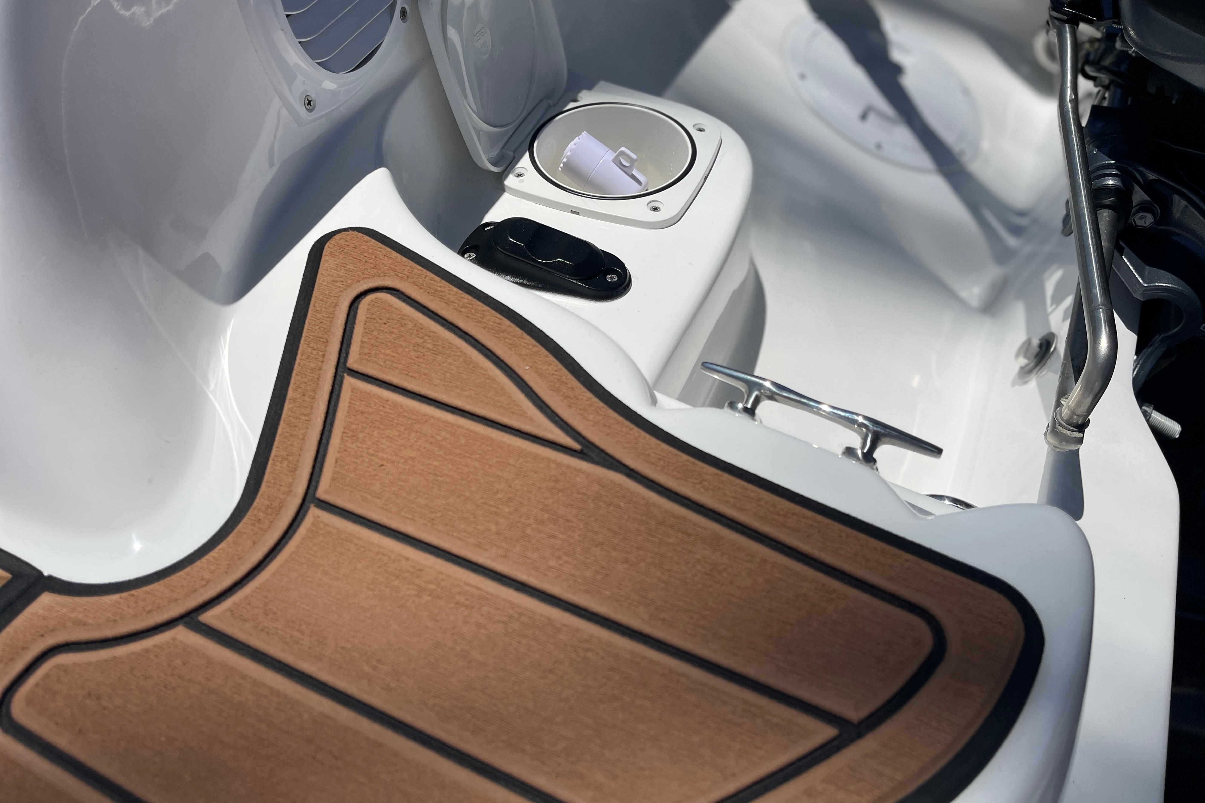 Interior of 2025 Caribe DL11 boat with wood-textured flooring and sleek design elements.