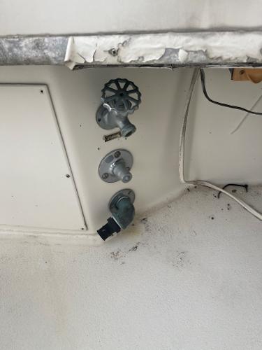 1985 Hatteras 45 Convertible boat interior with control valves and wiring.