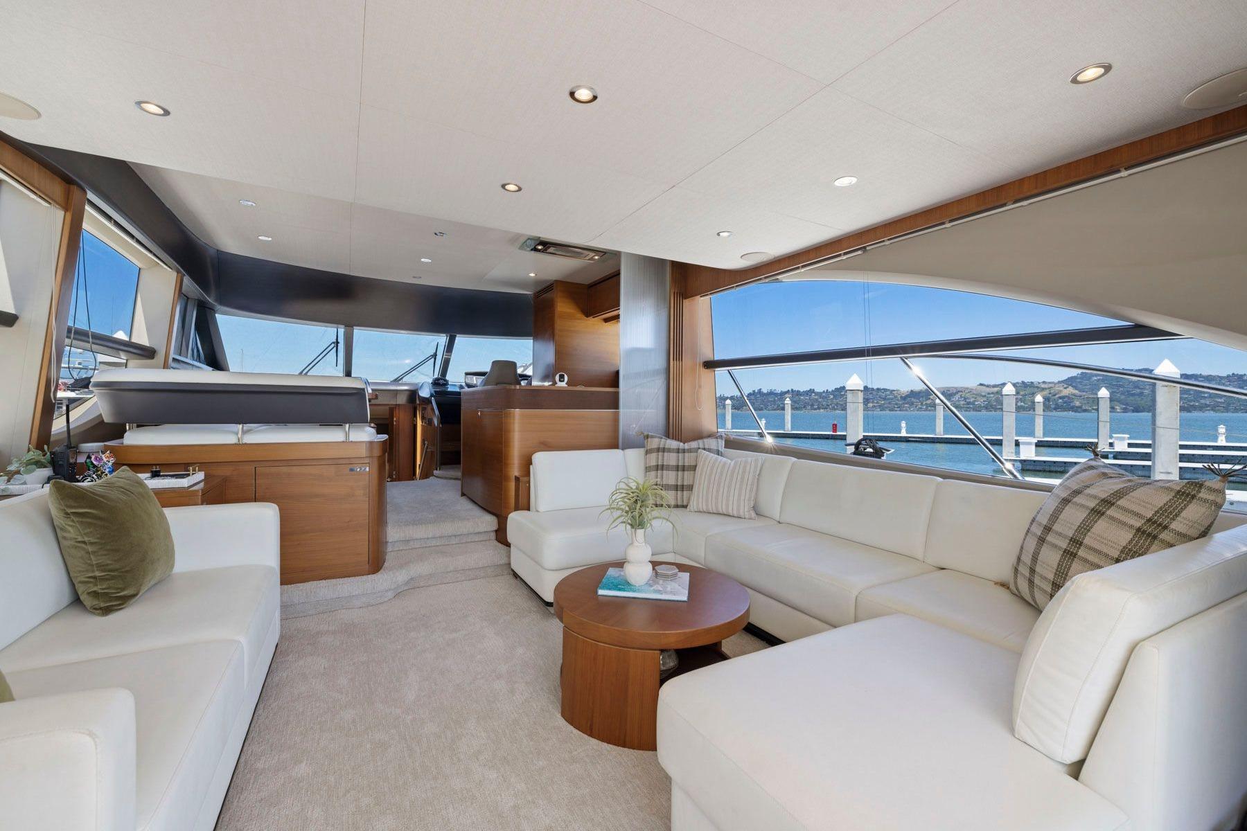 Luxurious interior of 2015 Princess 60 Flybridge Motor Yacht with elegant seating and scenic views.