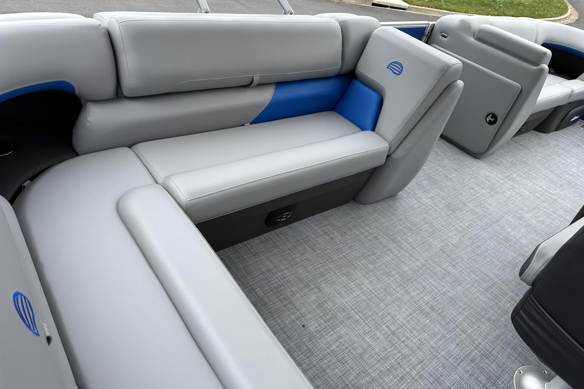 2026 Sun Tracker Party Barge 20 DLX interior with gray and blue seating.