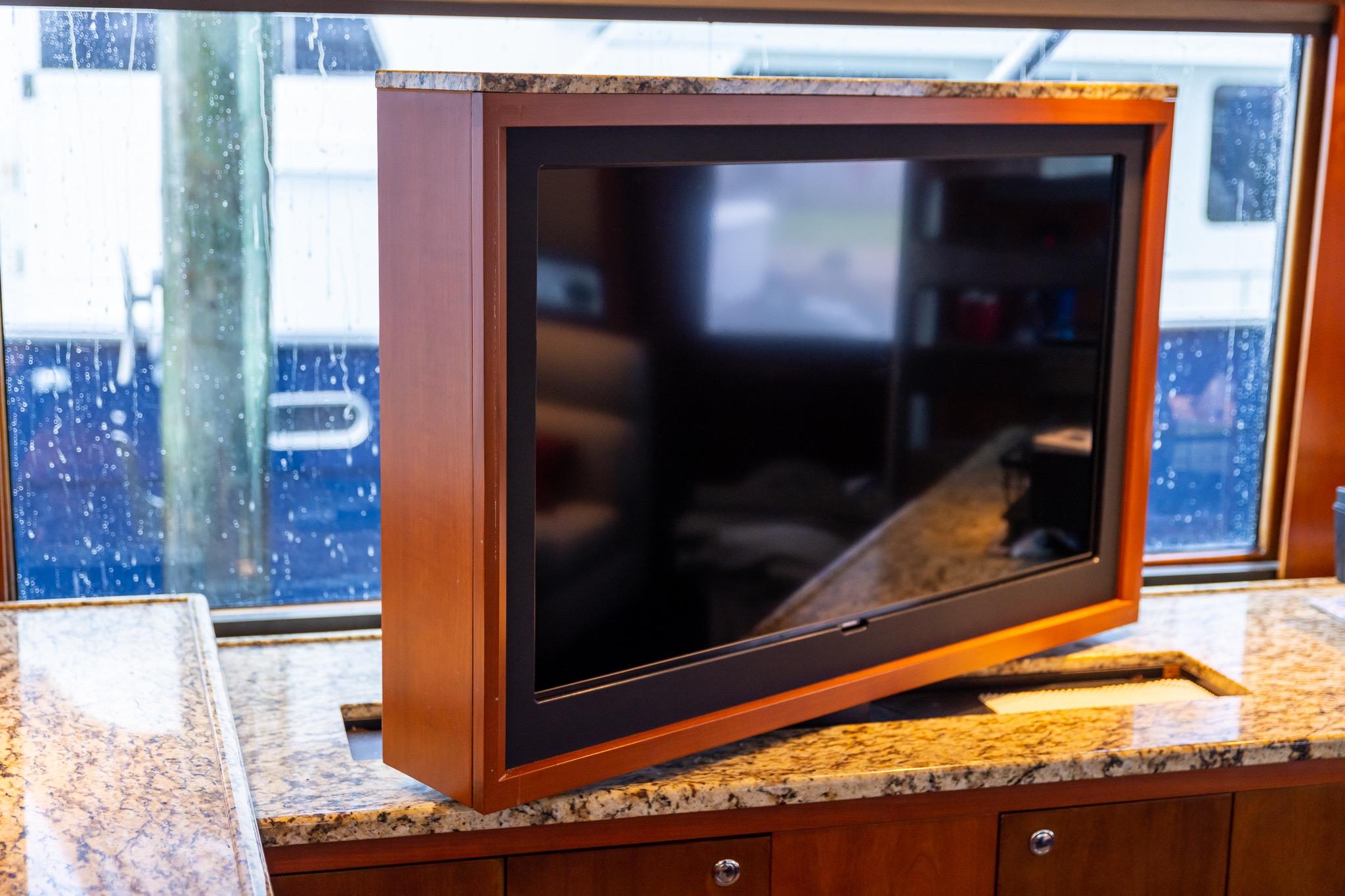 Flat-screen TV on granite counter inside 2000 Buddy Davis 78 Sportfisherman yacht.