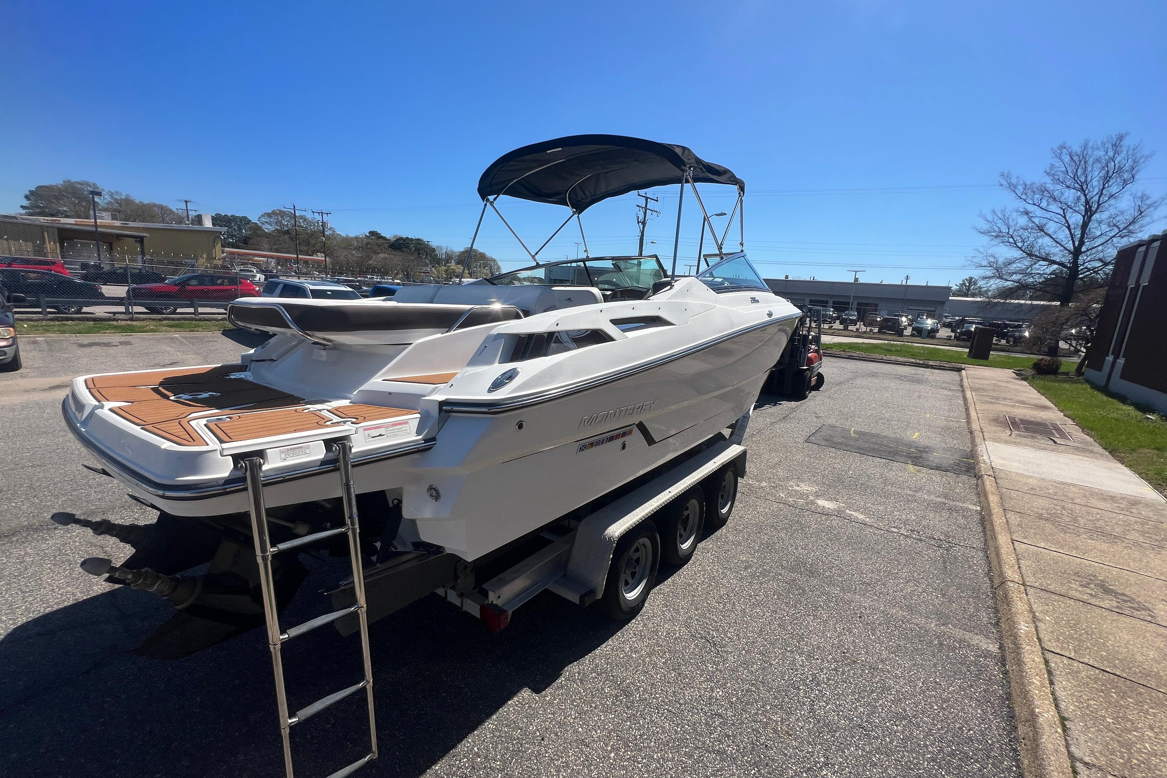 2017 Monterey 298SS Super Sport boat on trailer, parked outdoors under clear blue sky.