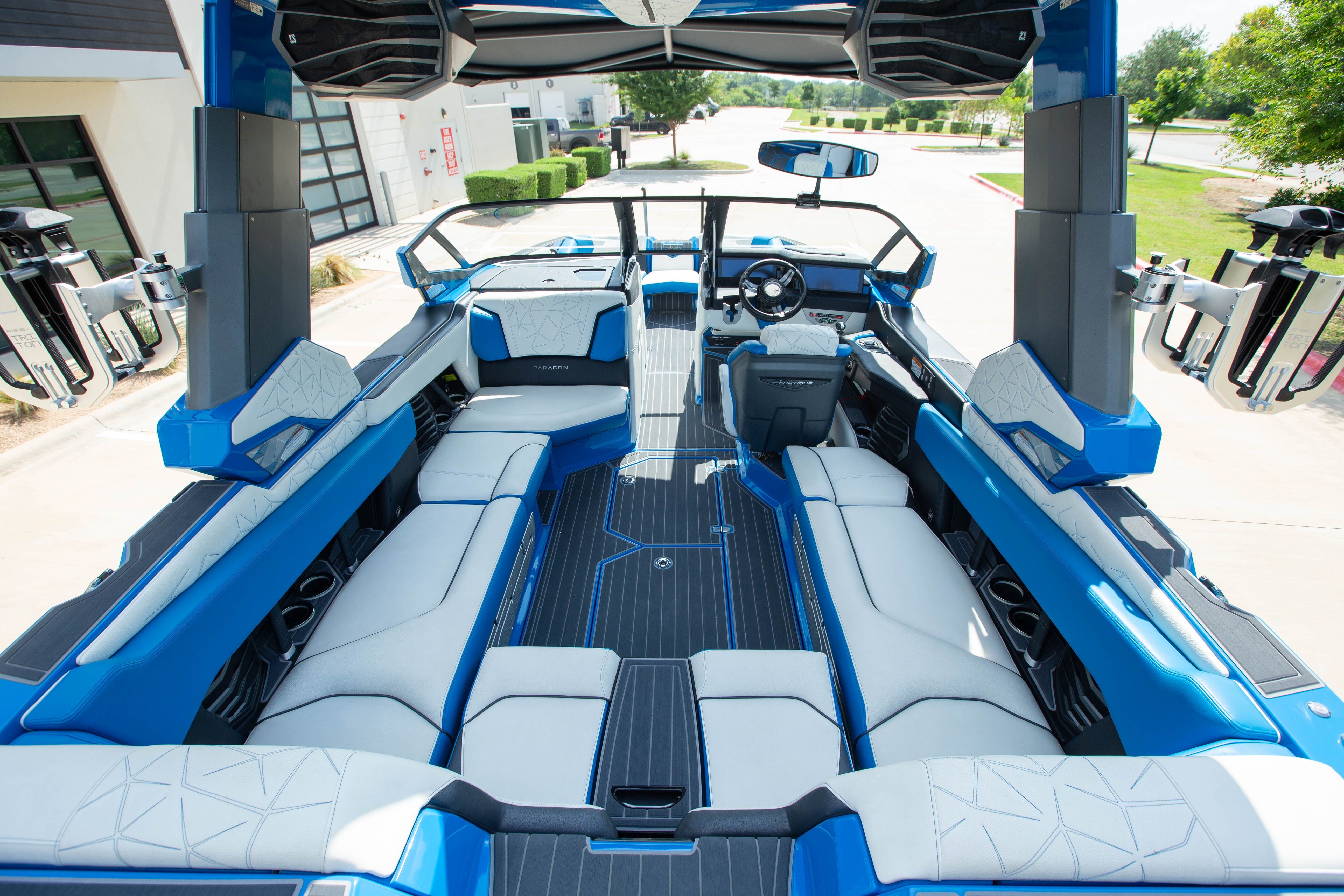 The boat features blue and white upholstery with modern fittings.