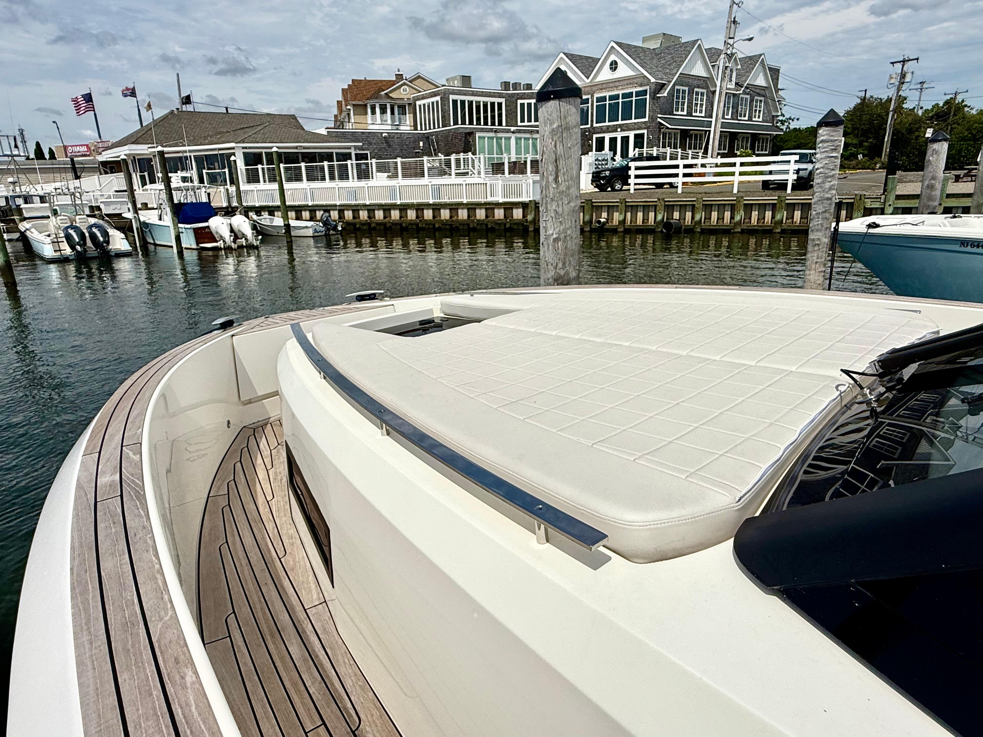 2023 Astondoa 377 Coupe Outboard docked at a marina with waterfront buildings.