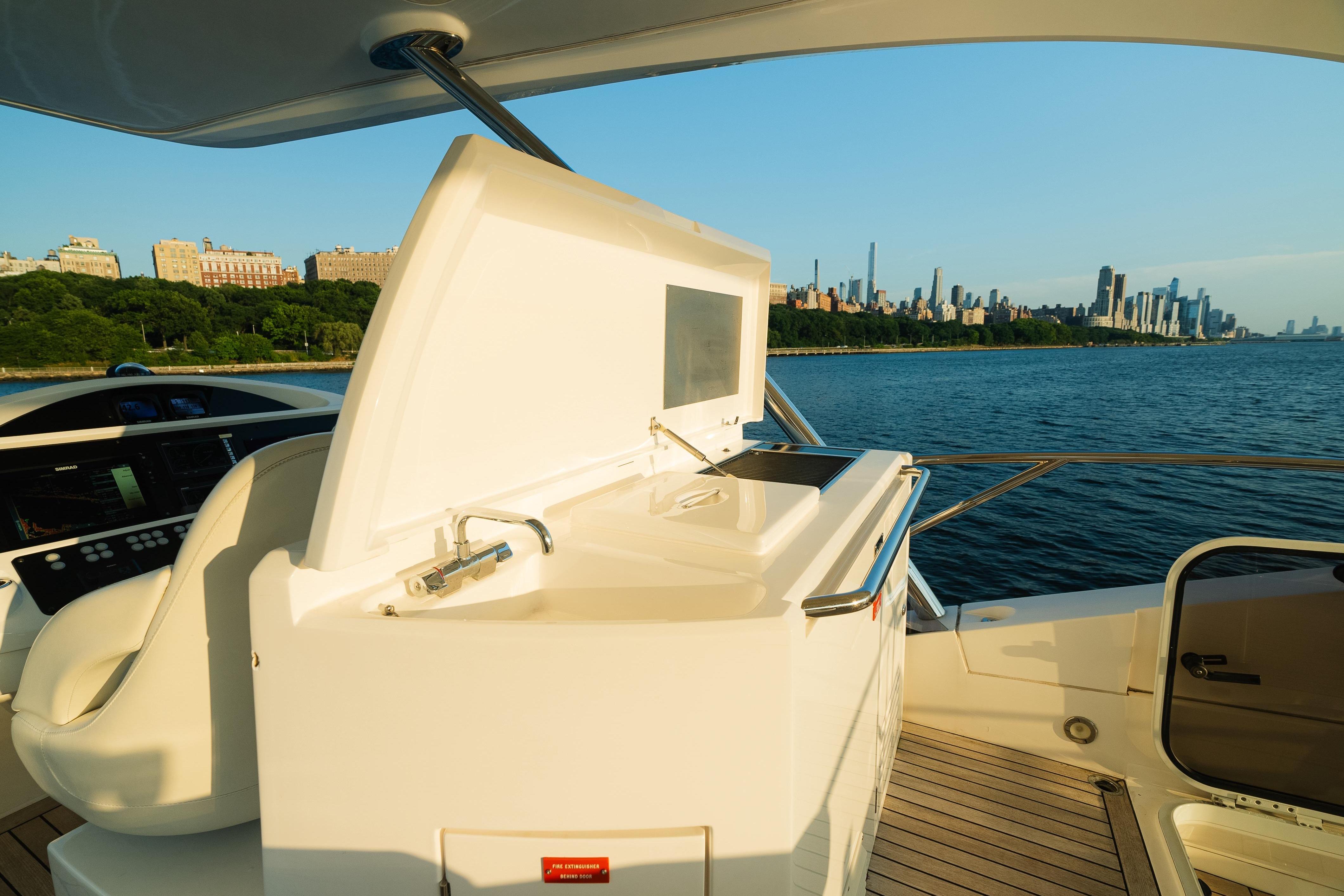 Luxurious 2016 Sunseeker Manhattan 65 yacht with city skyline and waterfront views.