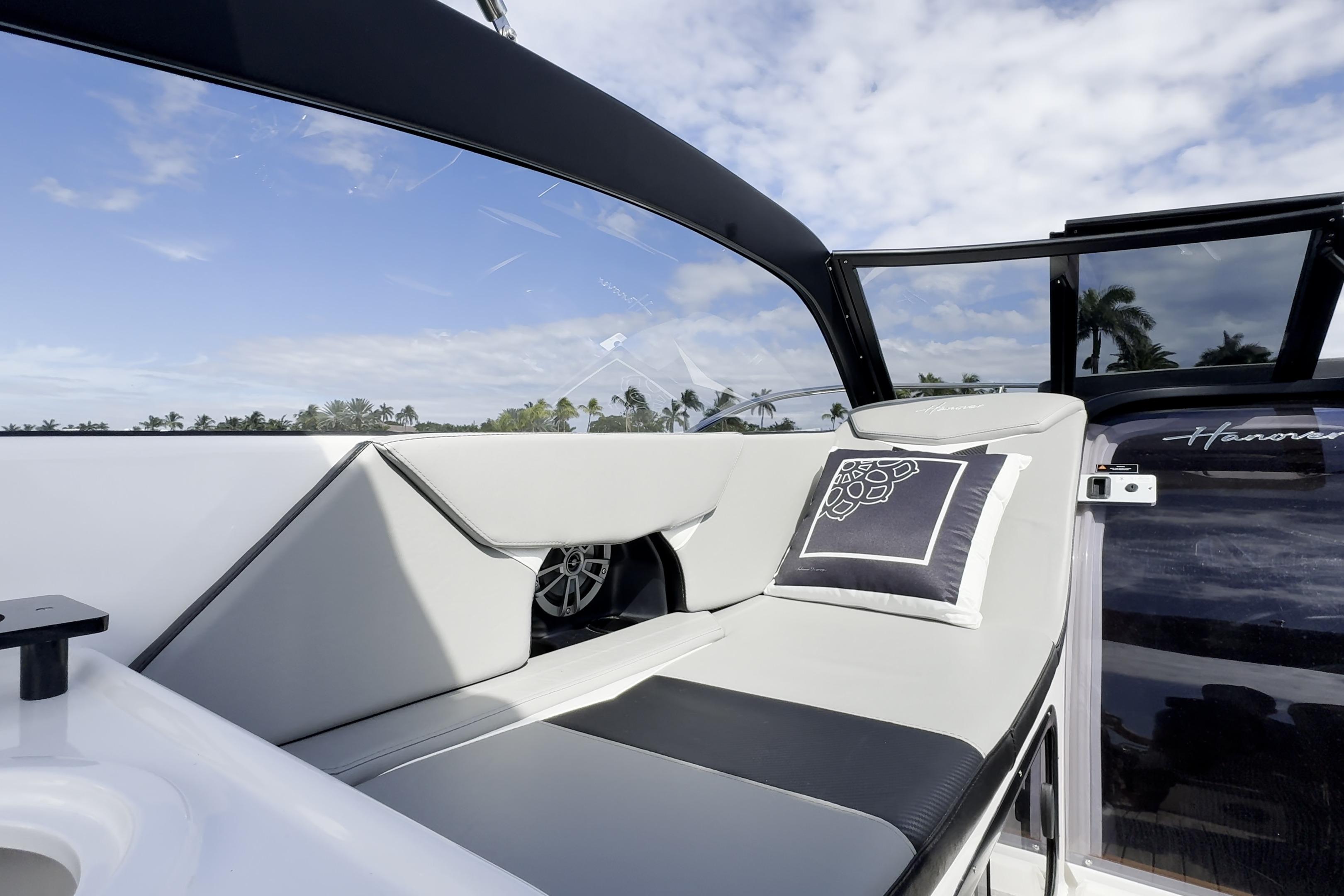 Luxurious seating on 2027 Hanover 305 boat with modern design and scenic view.