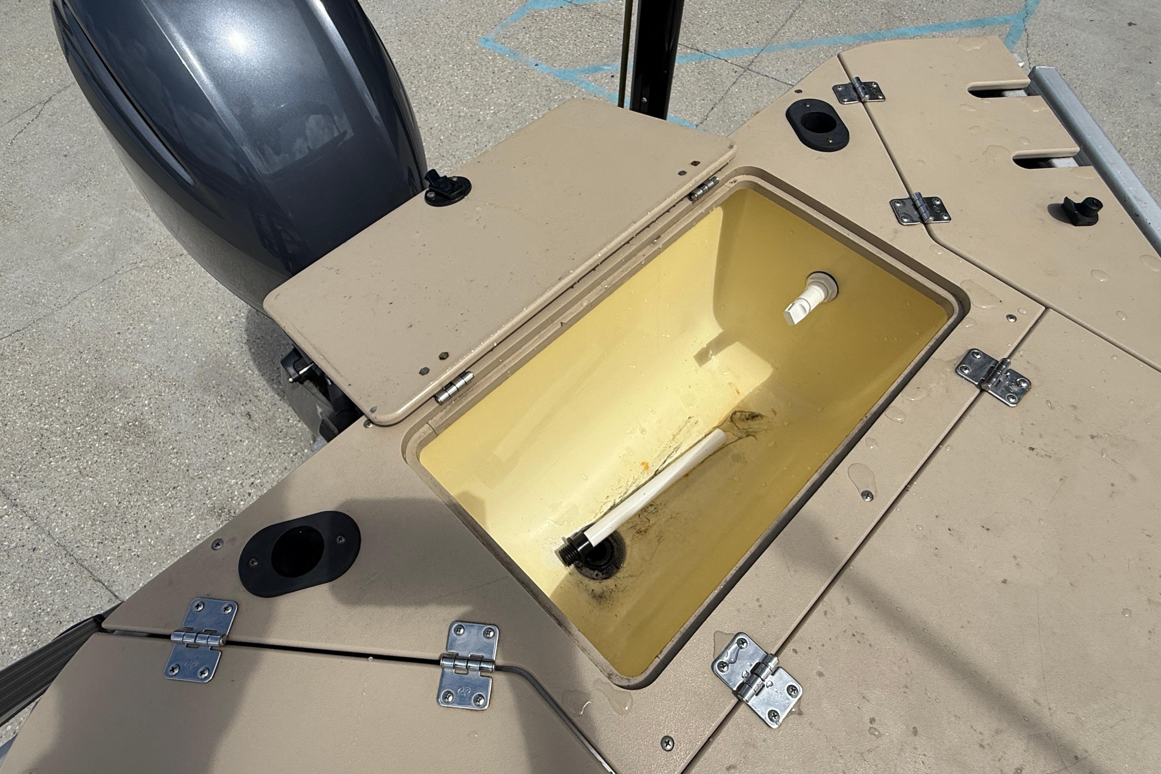 Open storage compartment on 2014 Godfrey Sweetwater 2486 C boat, showing interior details.