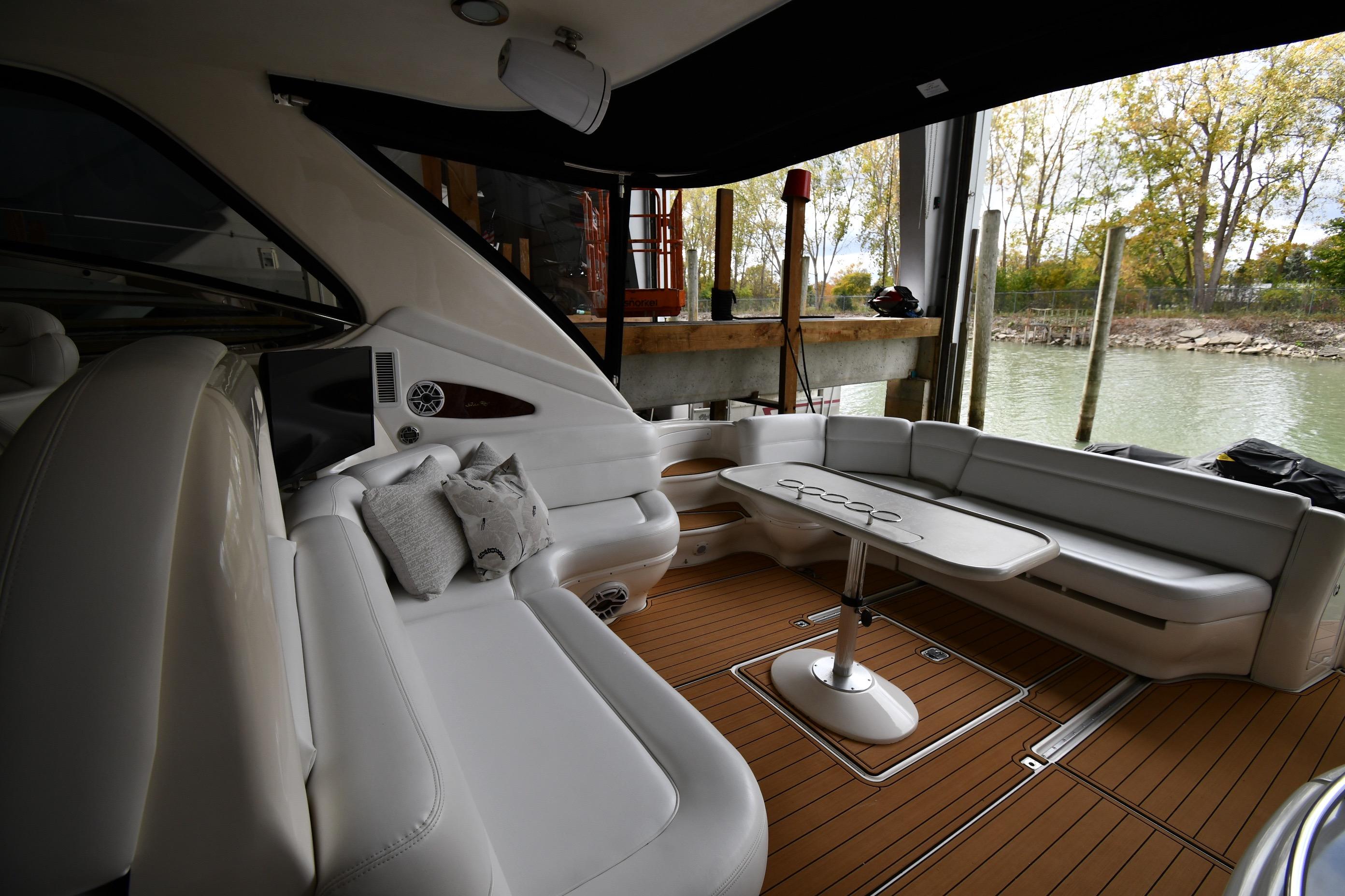 Luxurious 2001 Sea Ray 540 Sundancer yacht interior with plush seating and elegant table.