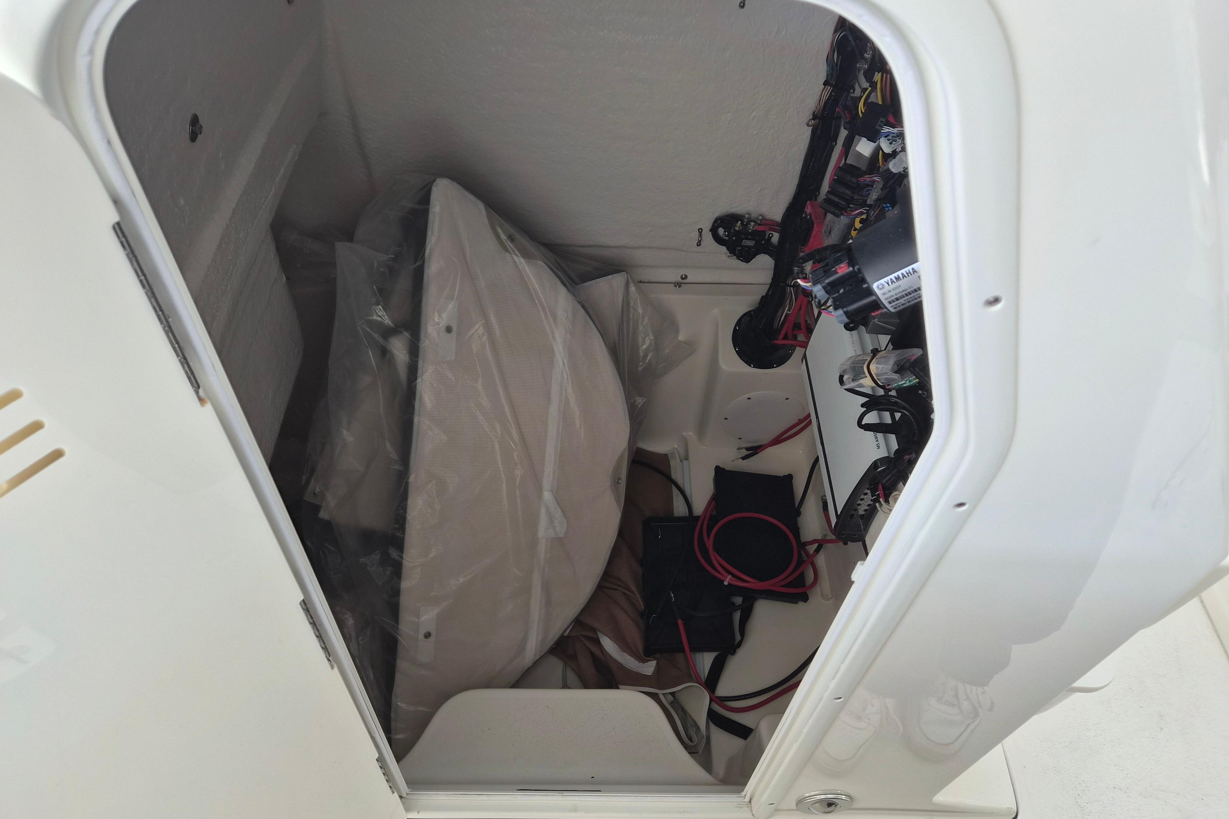 Interior view of 2026 Key West 260 Center Console boat compartment with wiring and equipment.