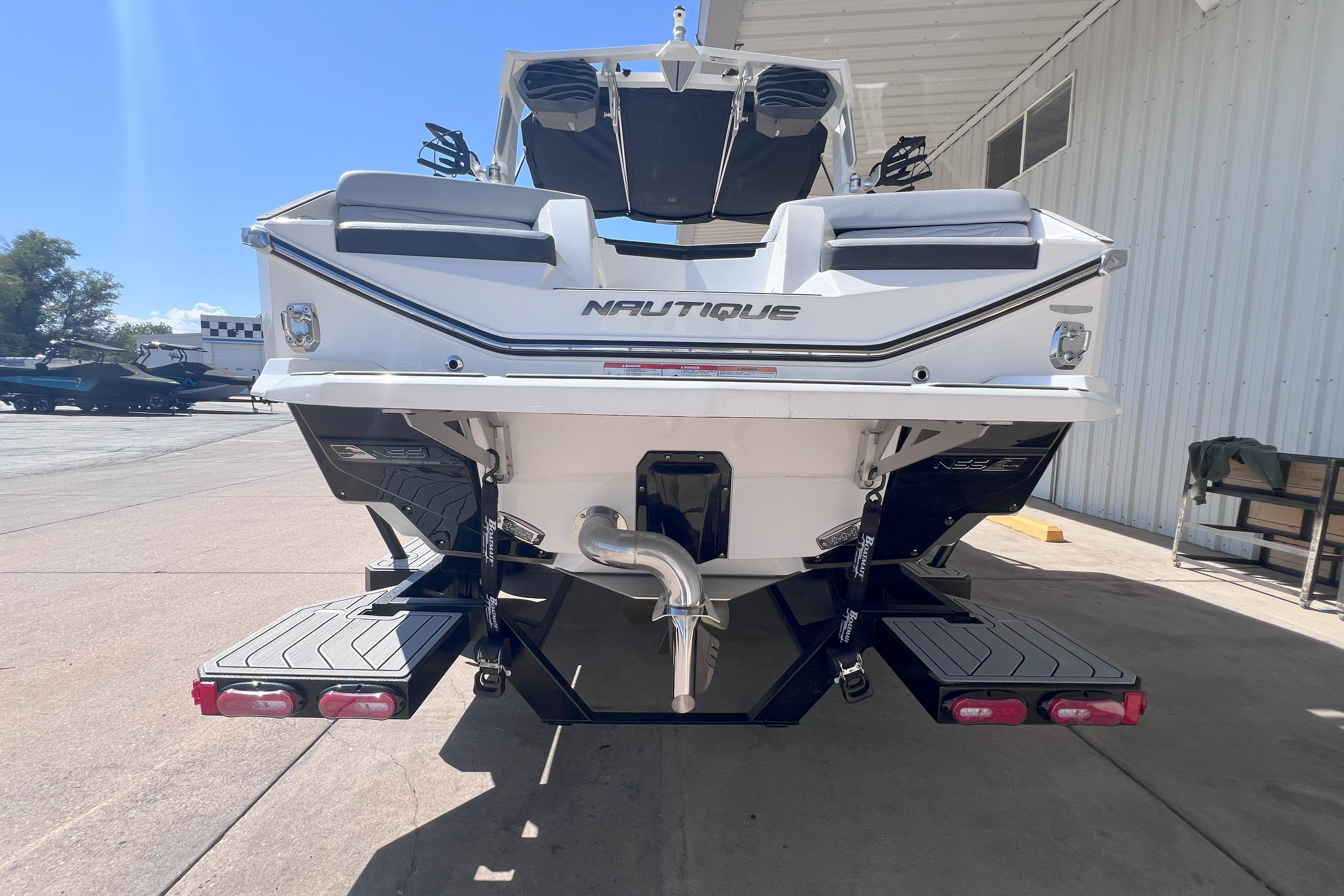 2025 Nautique Super Air Nautique G21 boat rear view at a marina.