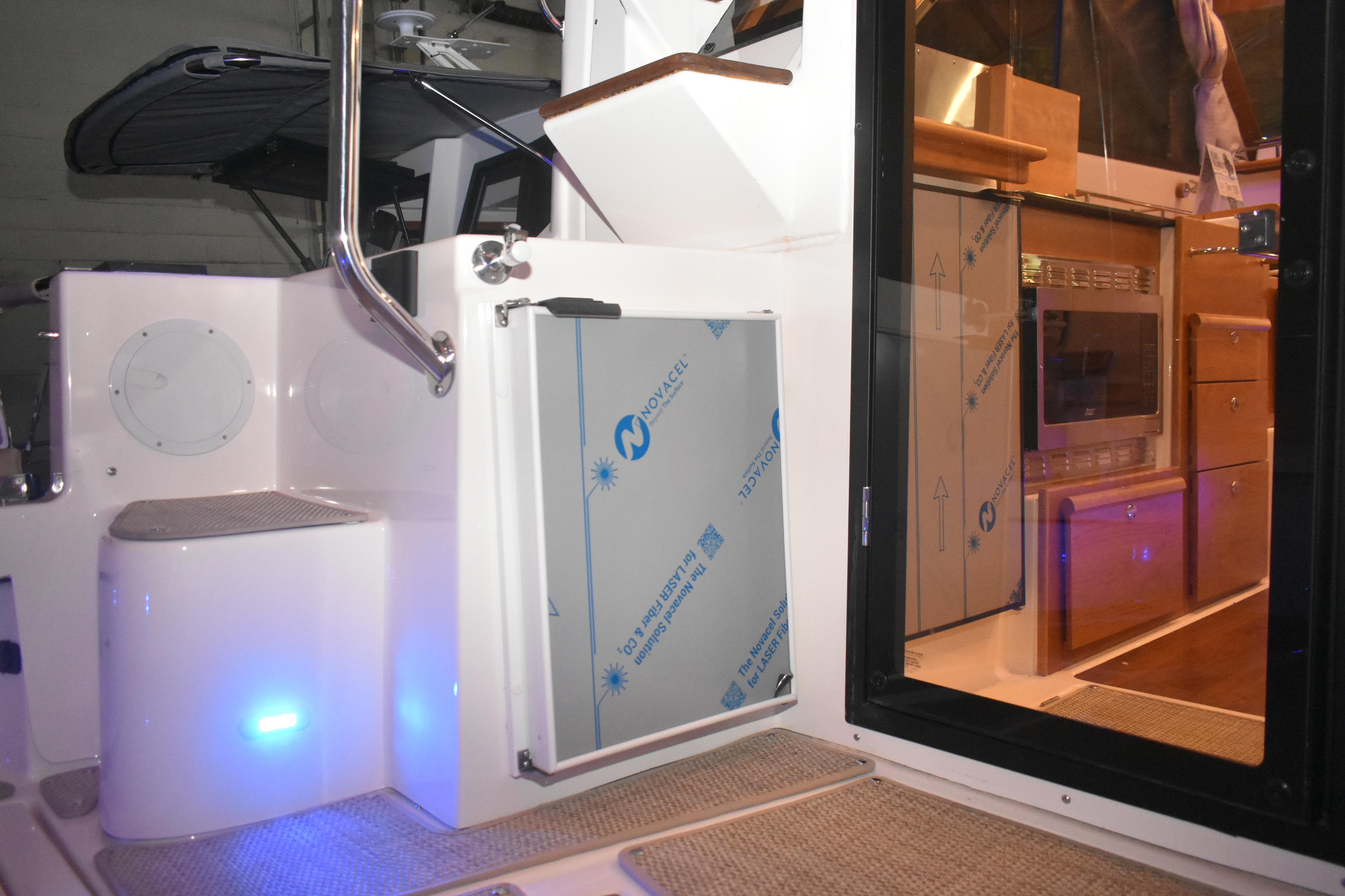 Interior view of 2026 Cutwater C-32 CB boat, featuring modern kitchen and sleek design.