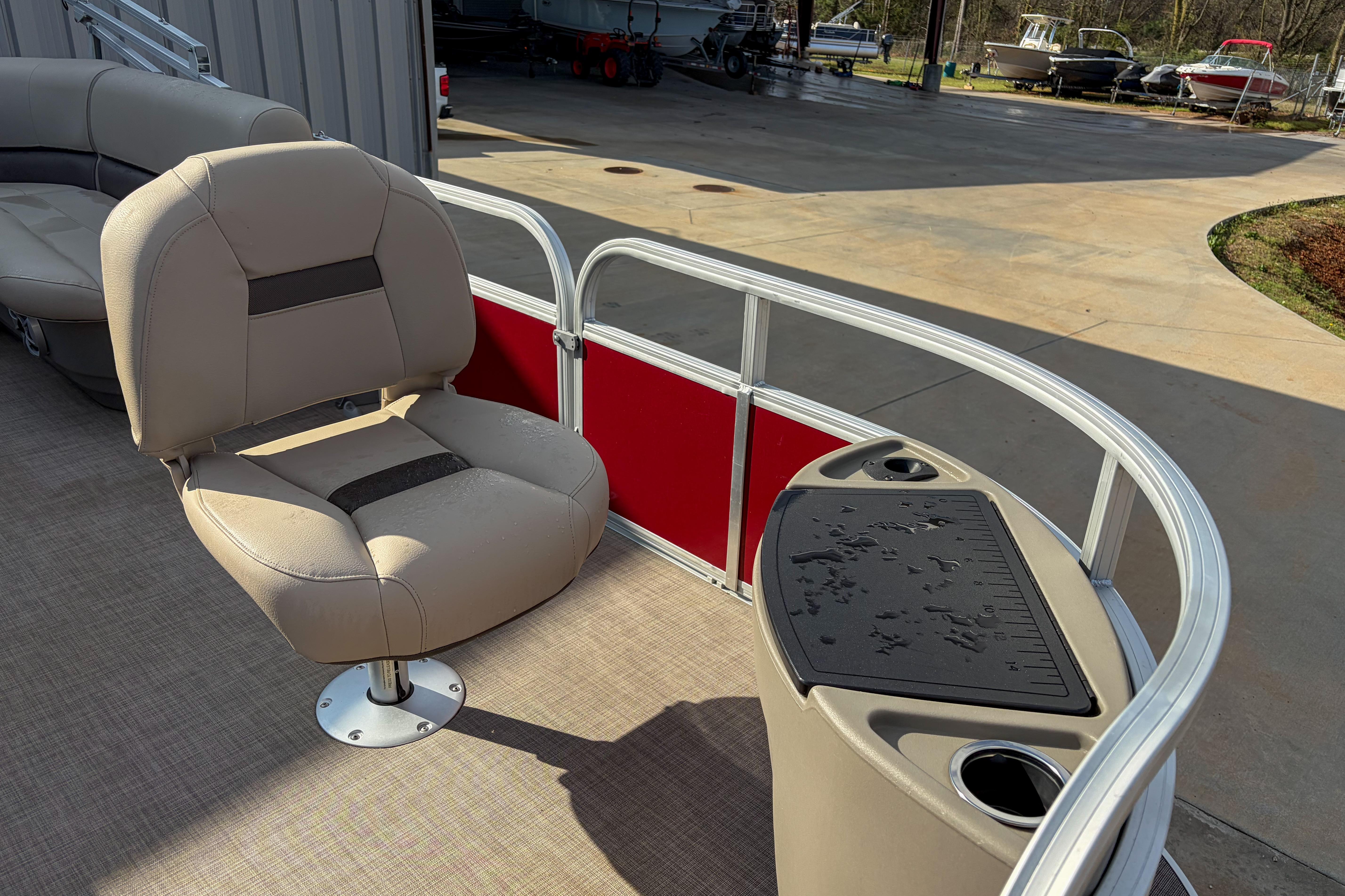 2024 Sun Tracker Bass Buggy 18 DLX pontoon boat with seating and fishing station.