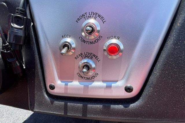Control panel of 2026 Tracker Pro Team 175 Crappie Edition boat with switches and horn button.