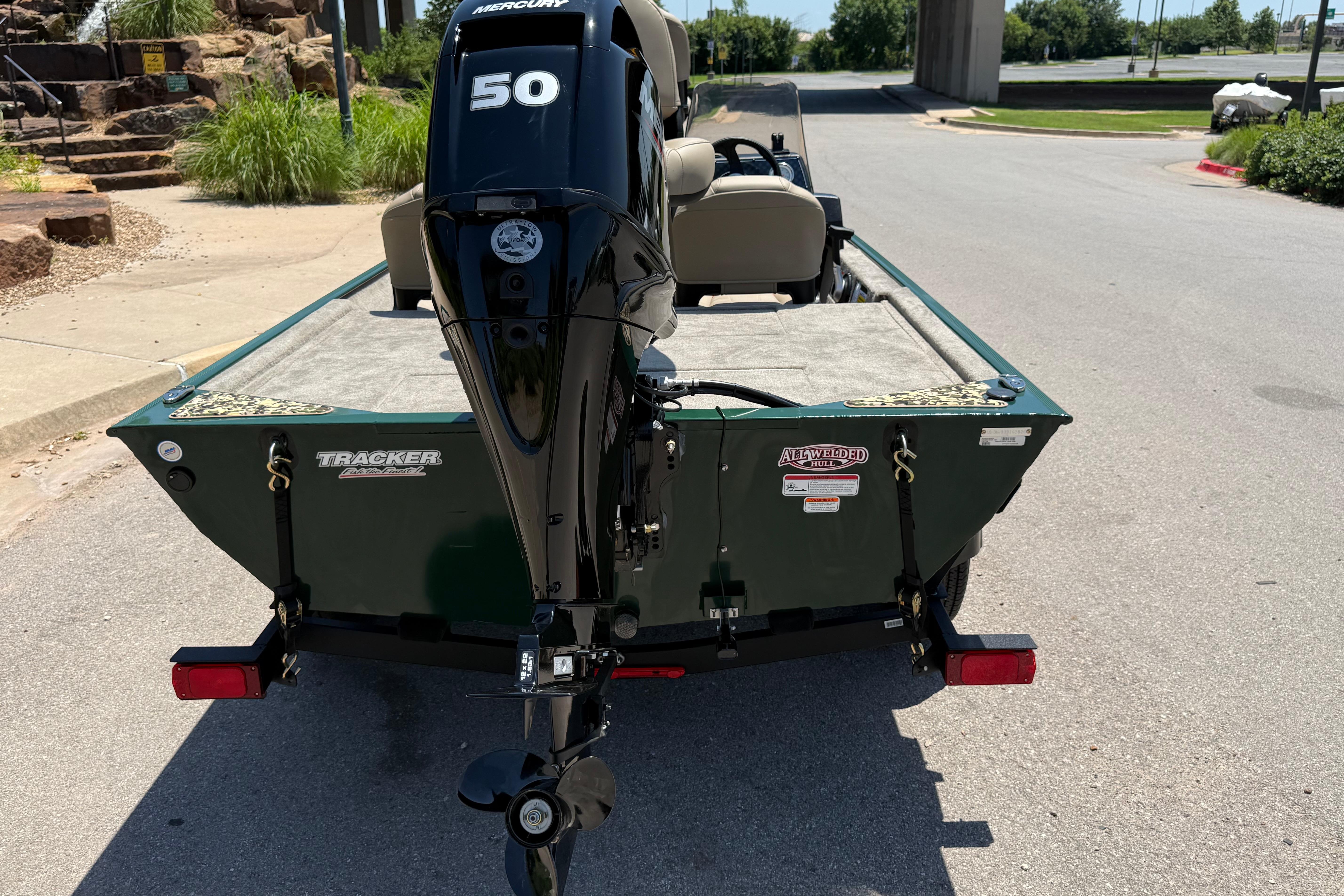 2026 Tracker Bass Tracker Classic Limited boat with Mercury 50 engine, parked outdoors.