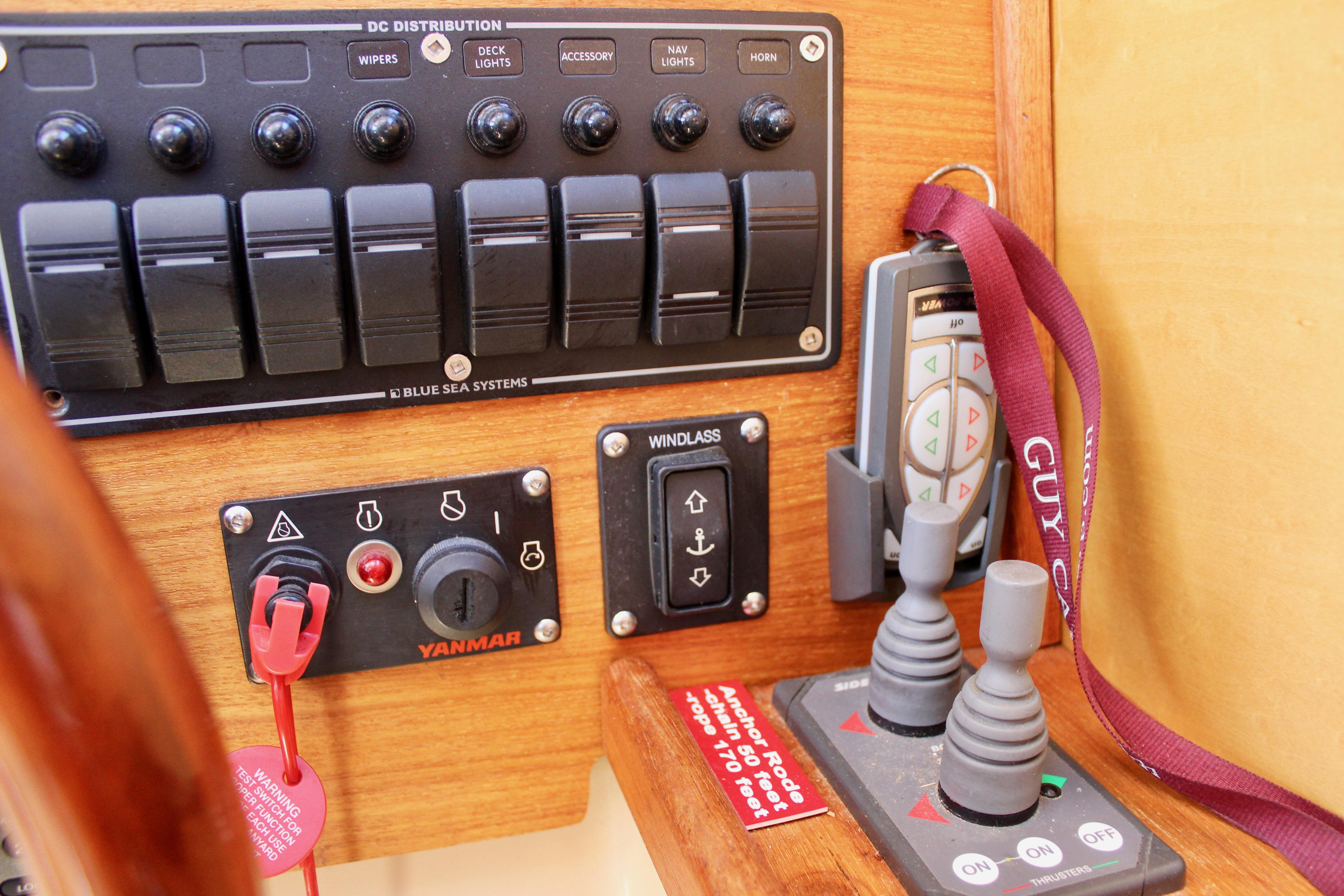 Control panel of a 2011 Ranger Tugs R-27 boat with switches and joysticks.