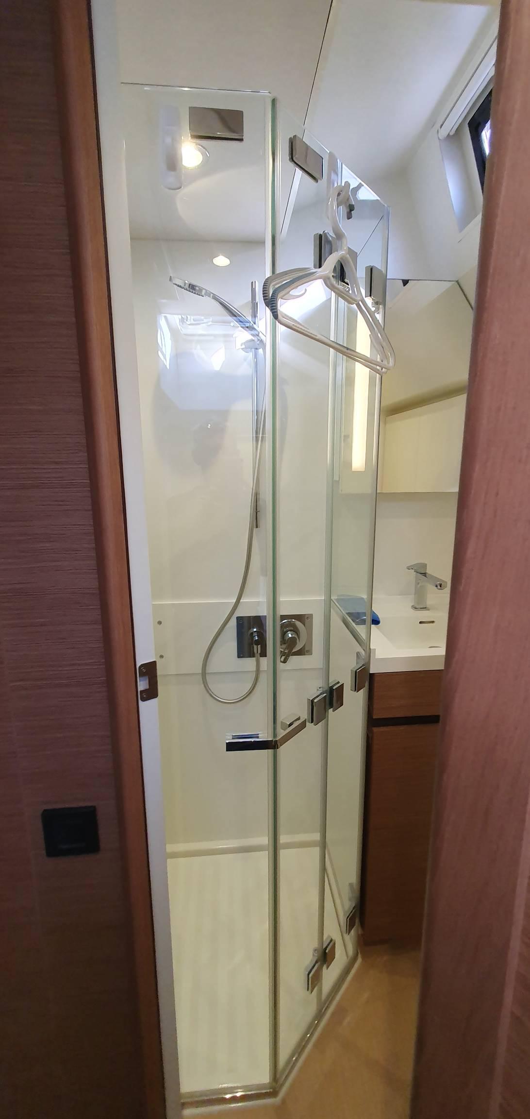 Modern glass shower enclosure in 2018 CNB 66 yacht bathroom.