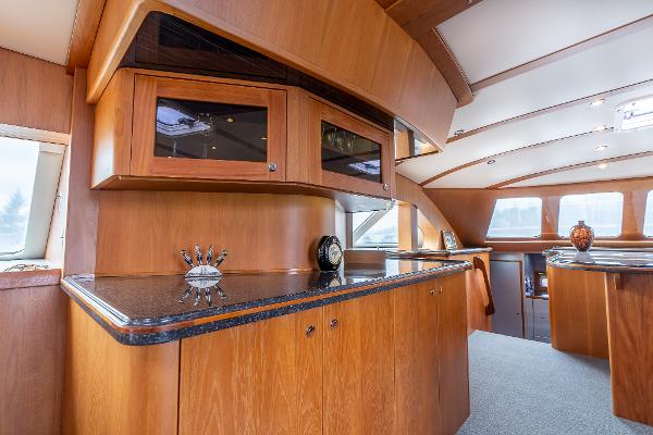 Luxurious interior of 2025 Shuttleworth 52 AeroRig yacht with elegant wood cabinetry.