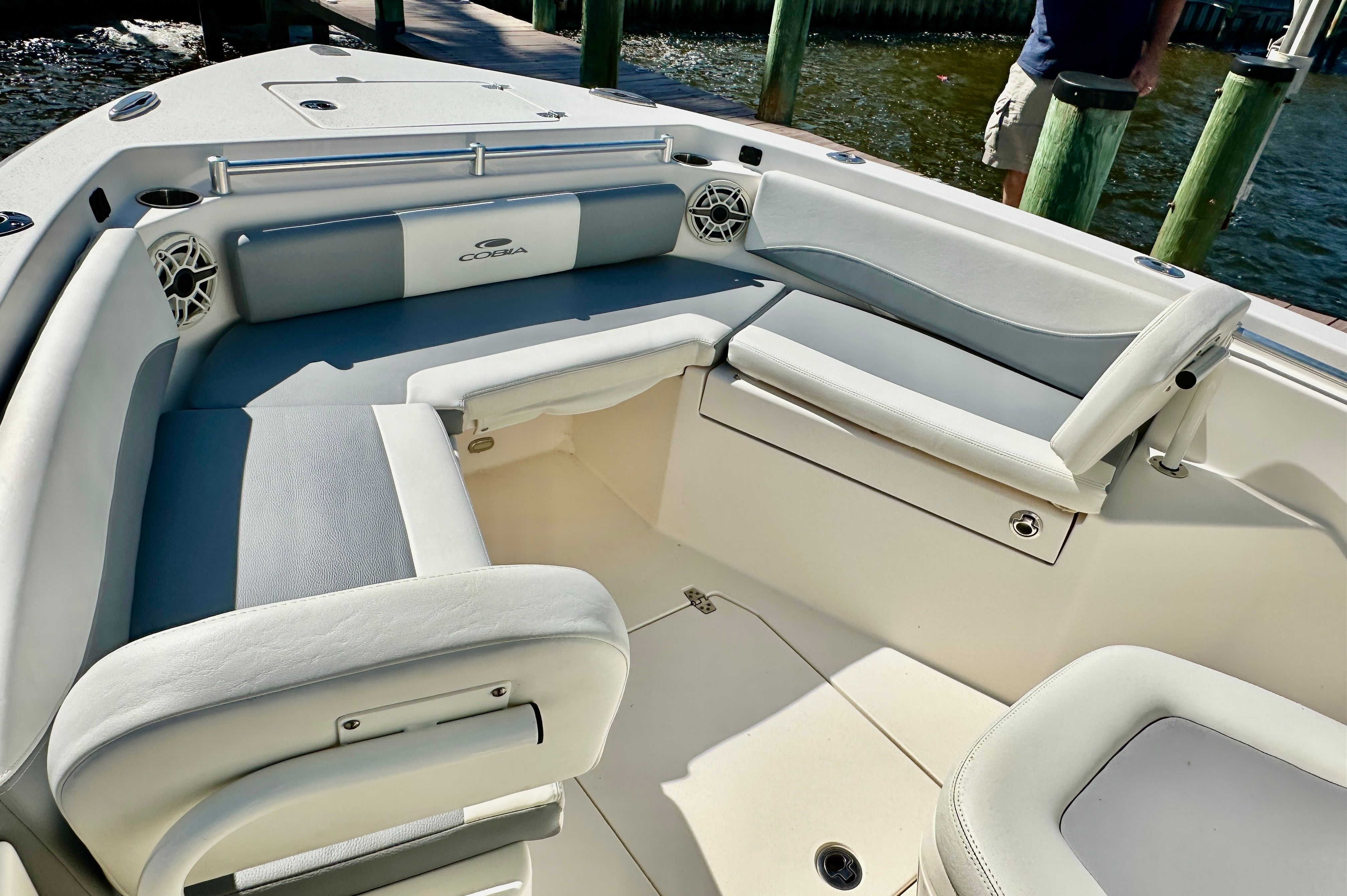 The image shows the cockpit of a 2022 Cobia 240 Center Console boat with comfortable seating.