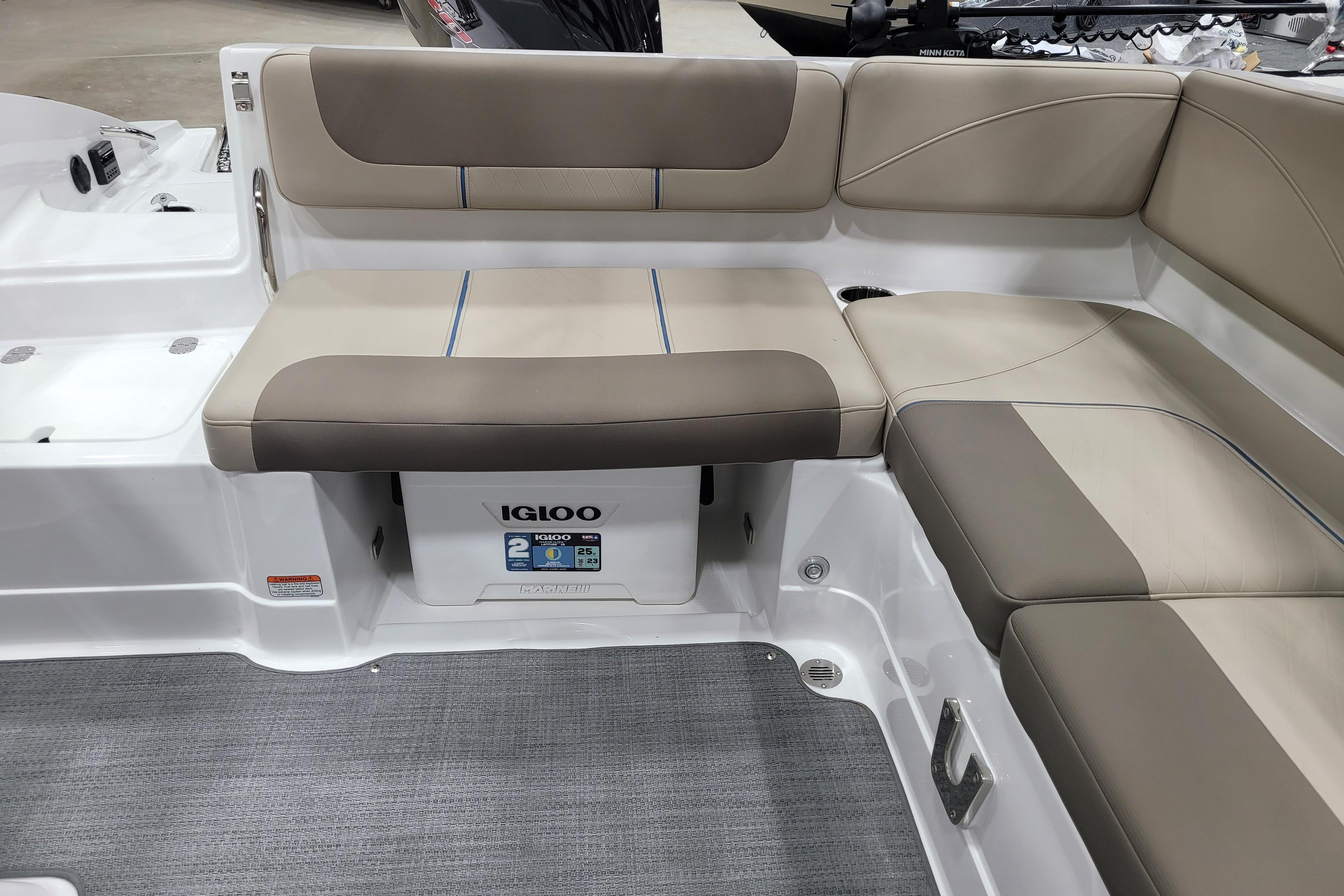 2026 Tahoe 2150 boat interior with beige seating and Igloo cooler storage.