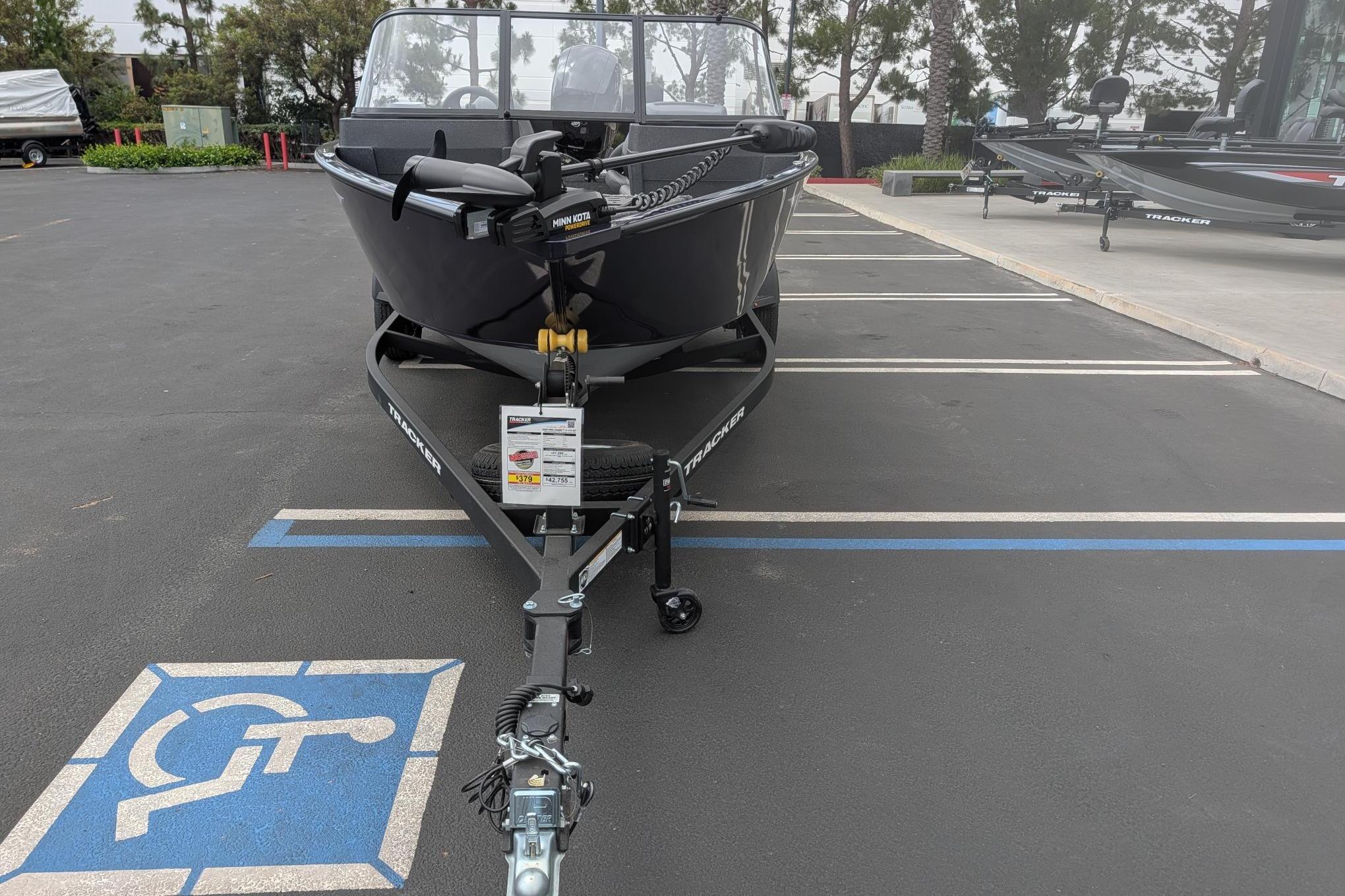 2026 Tracker Pro Guide V-175 WT boat on trailer in parking lot.