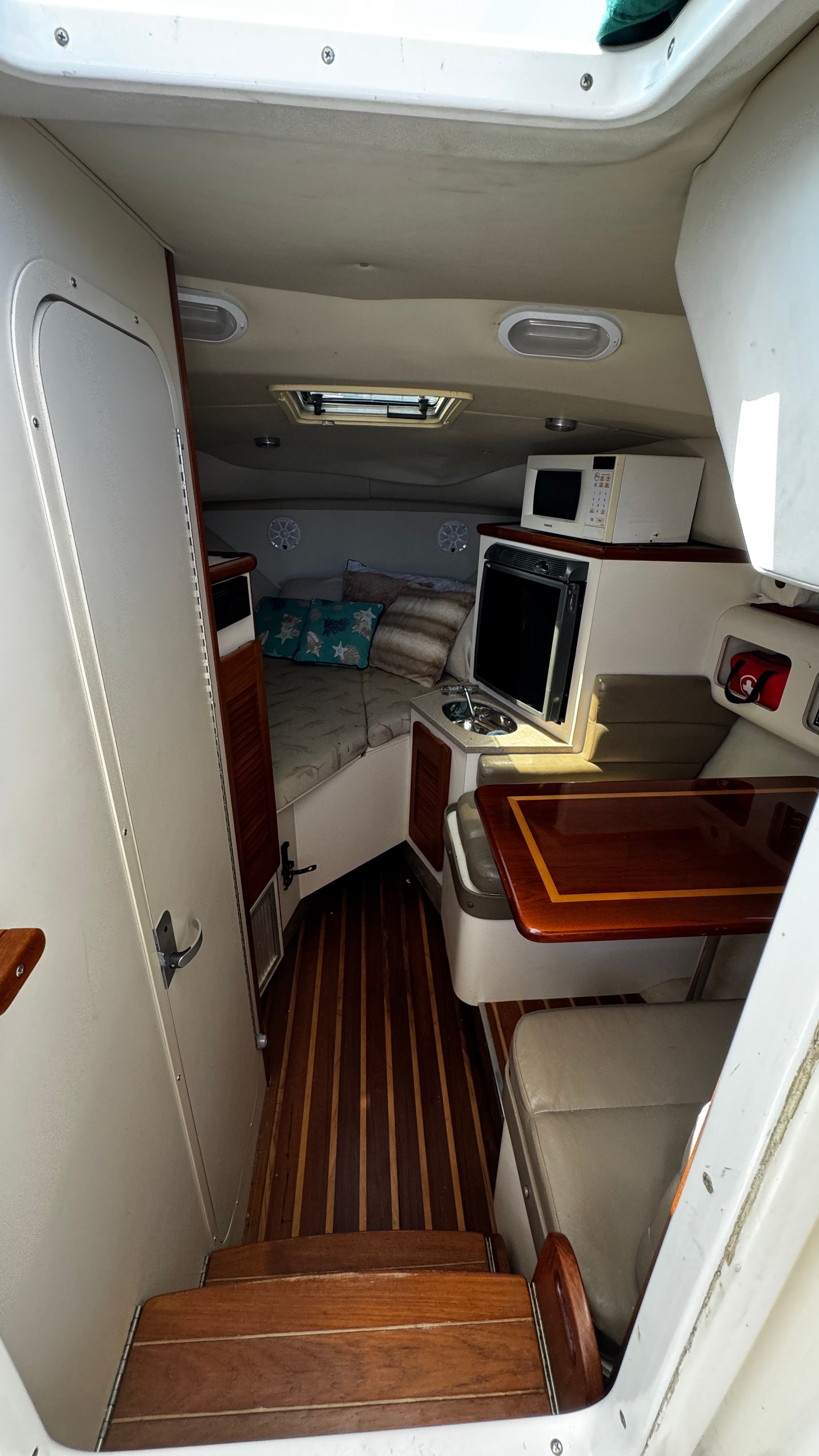 Interior of a 2003 Pursuit 3070 with sleeping area and kitchenette.