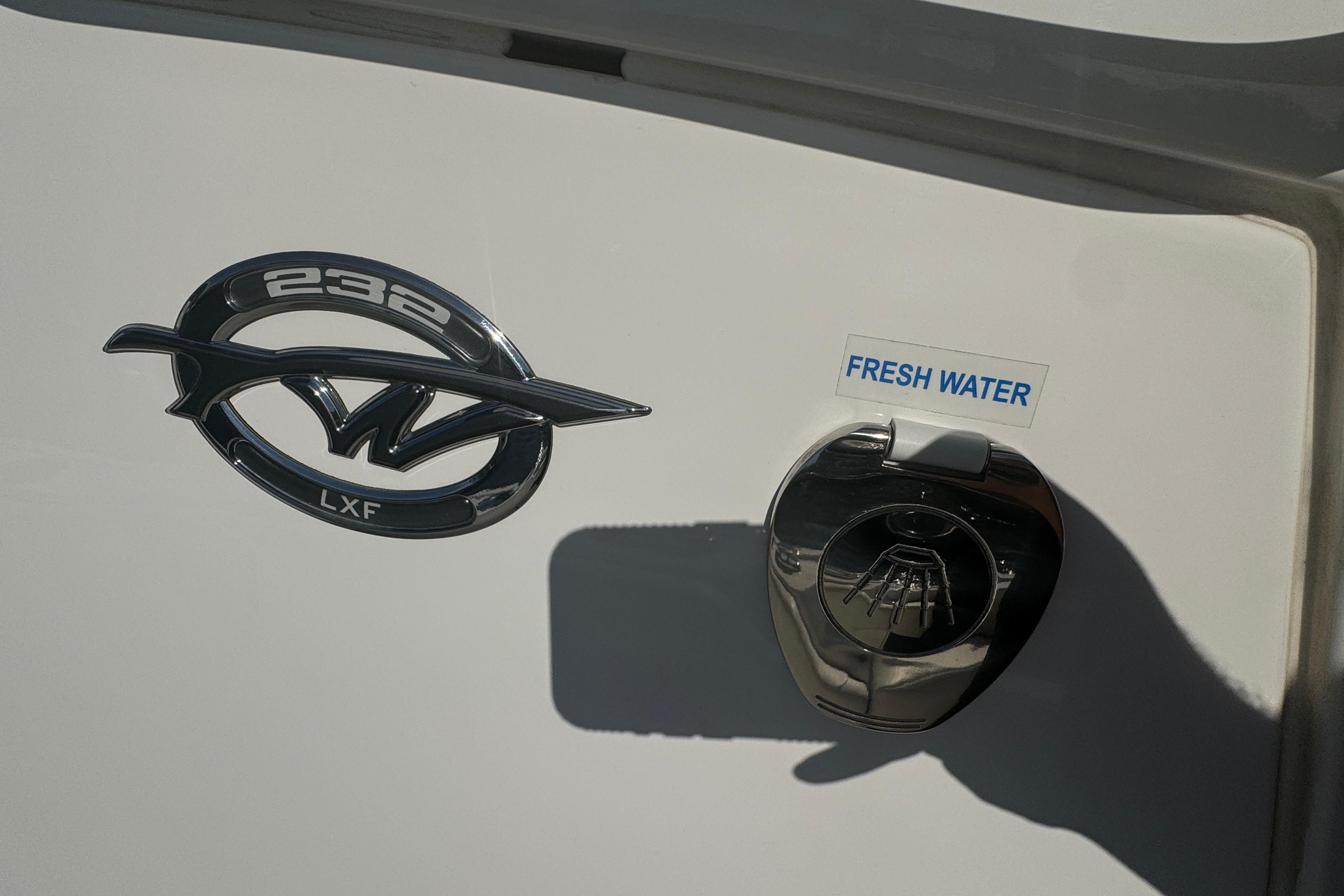 2025 Tidewater 232 LXF boat emblem and fresh water access point.