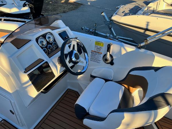 2024 Starcraft SVX 191 boat cockpit with steering wheel and captain's chair.