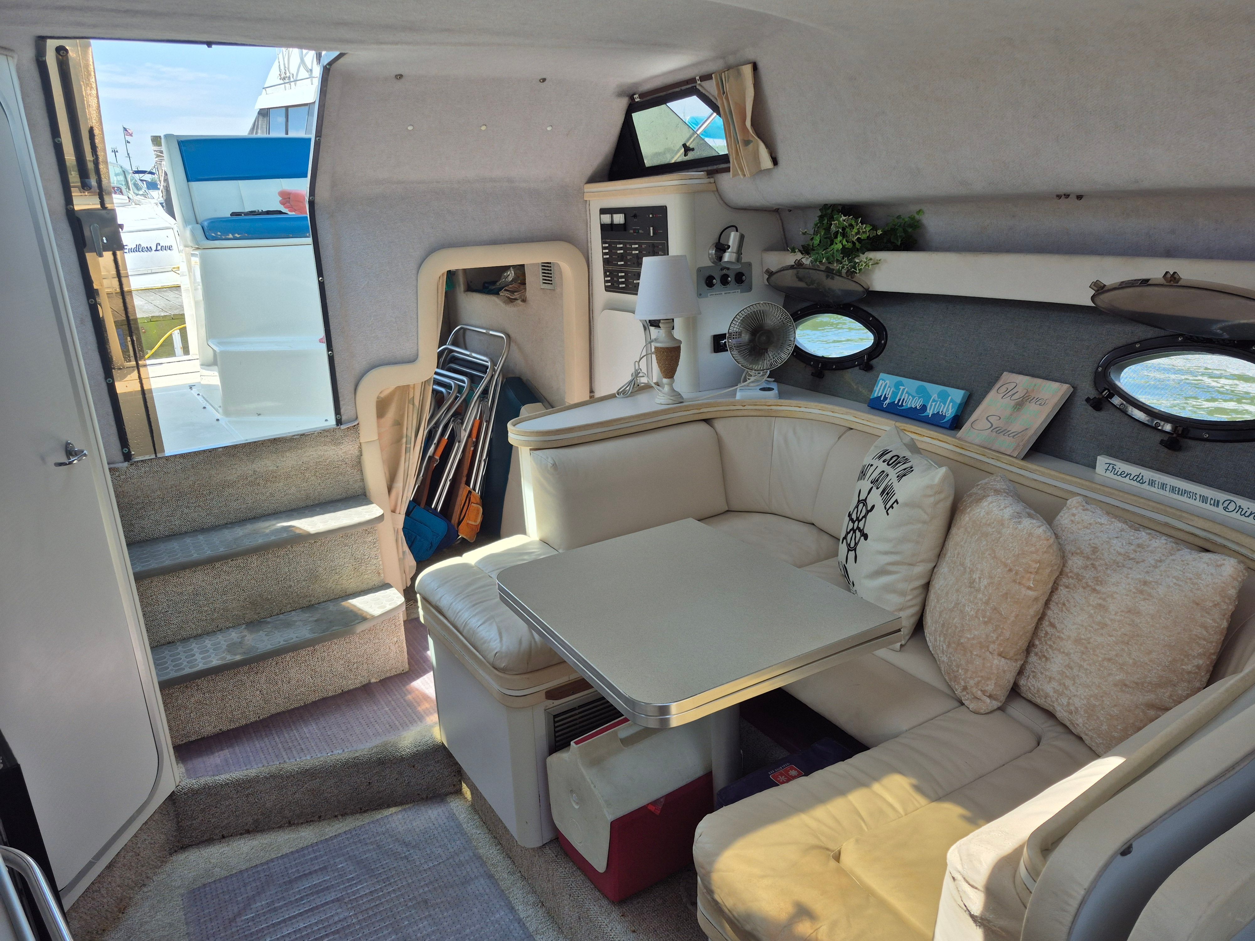 Interior of a 1989 Tiara Yachts Slickcraft with a cozy seating area and table.