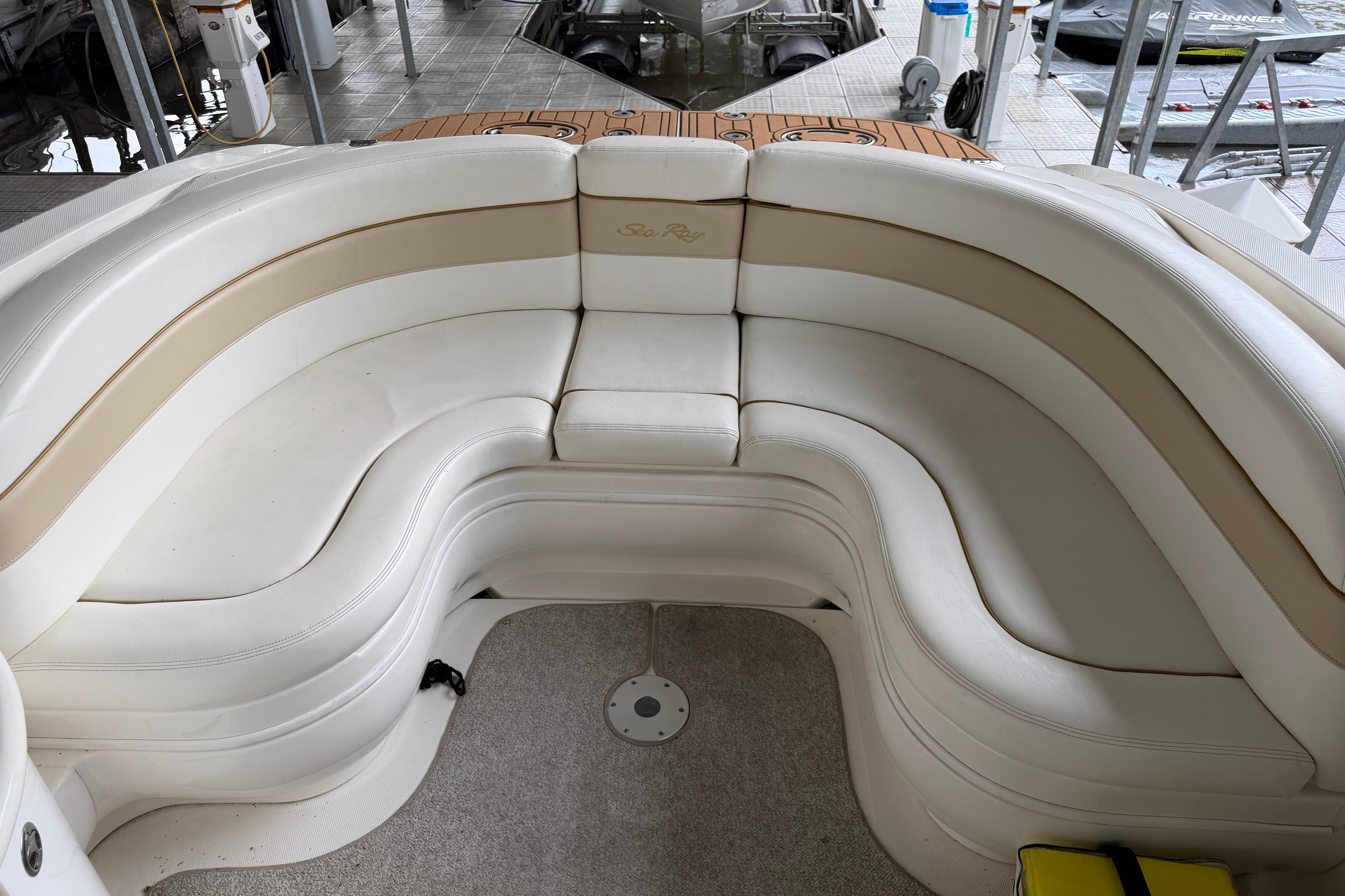 2003 Sea Ray 290 Bowrider interior with white and beige seating arrangement.