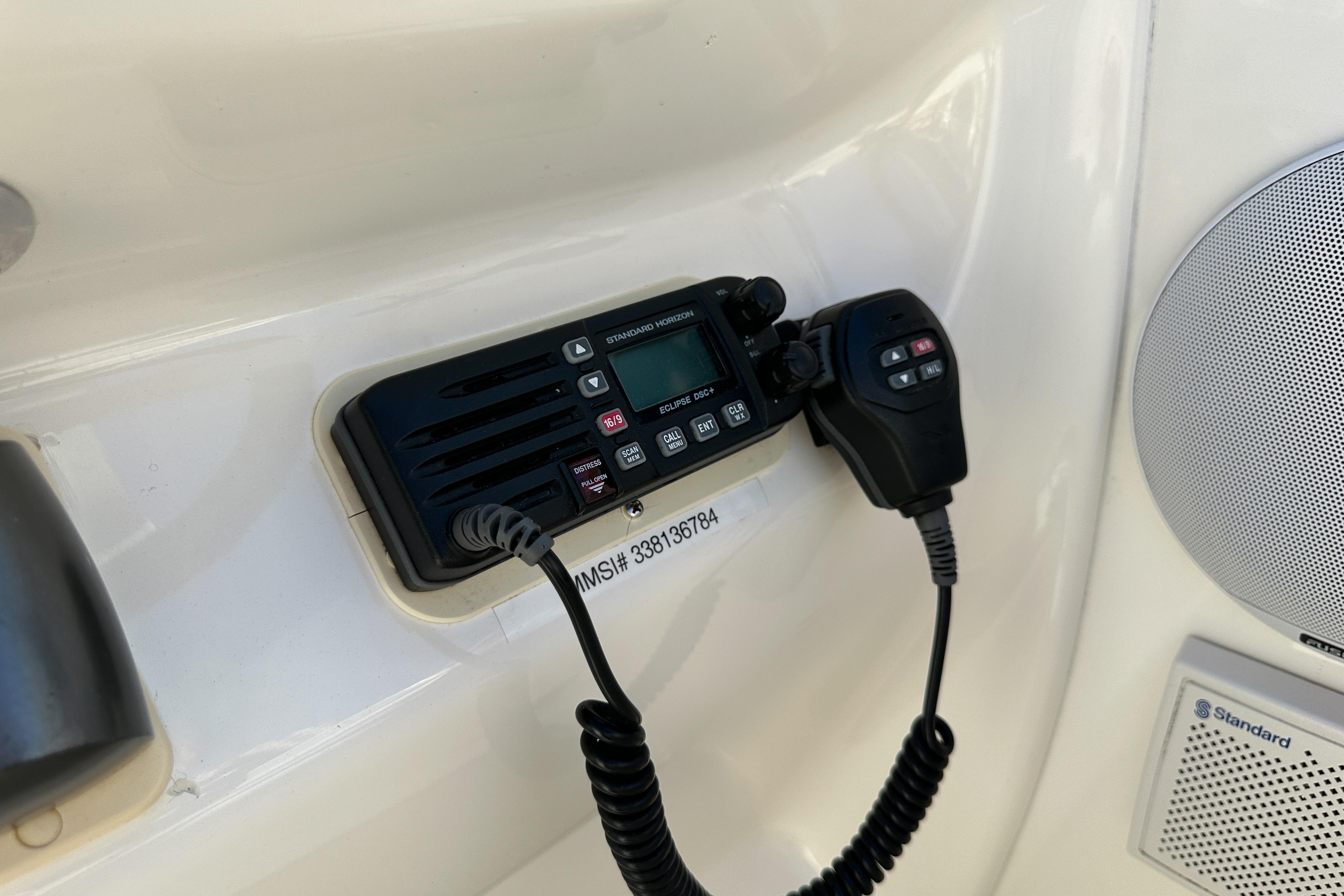 VHF radio and speaker on 1998 Sea Ray 215 Express Cruiser boat dashboard.