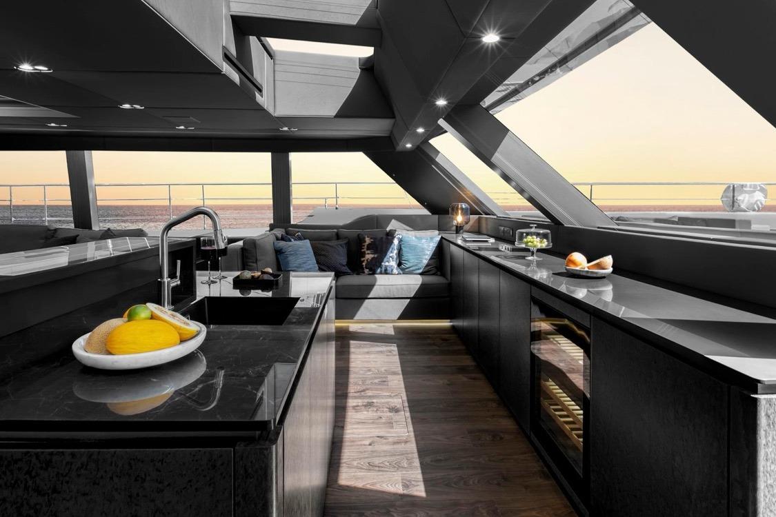 Luxurious interior of 2020 Sunreef 80 Power yacht with modern kitchen and ocean view.