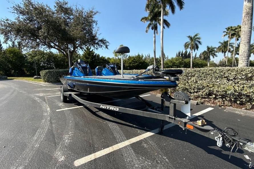 2026 Nitro Z19 XL boat on trailer in sunny parking lot with palm trees.