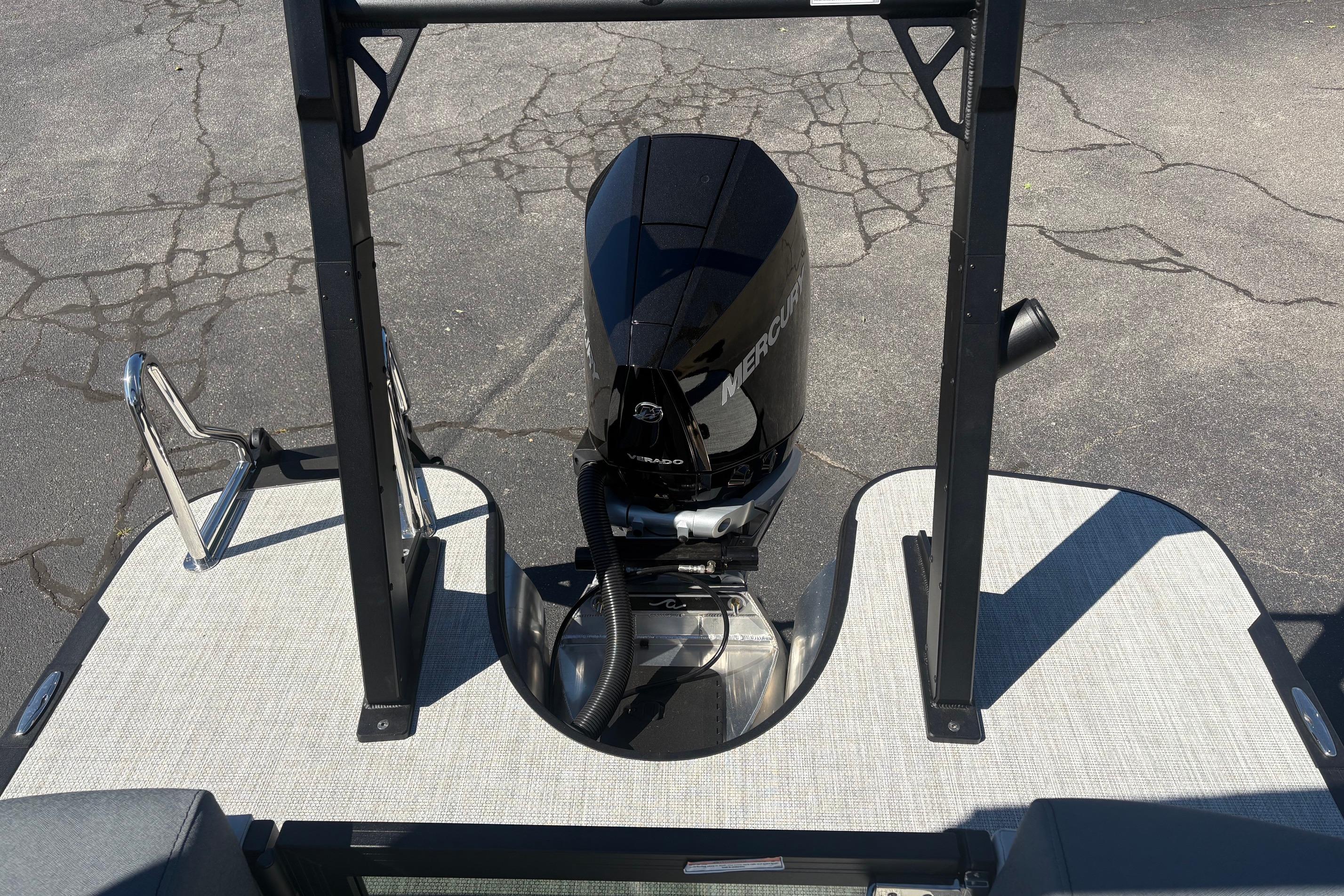 Alera 23Q 2026 boat with Mercury outboard motor on a textured deck.