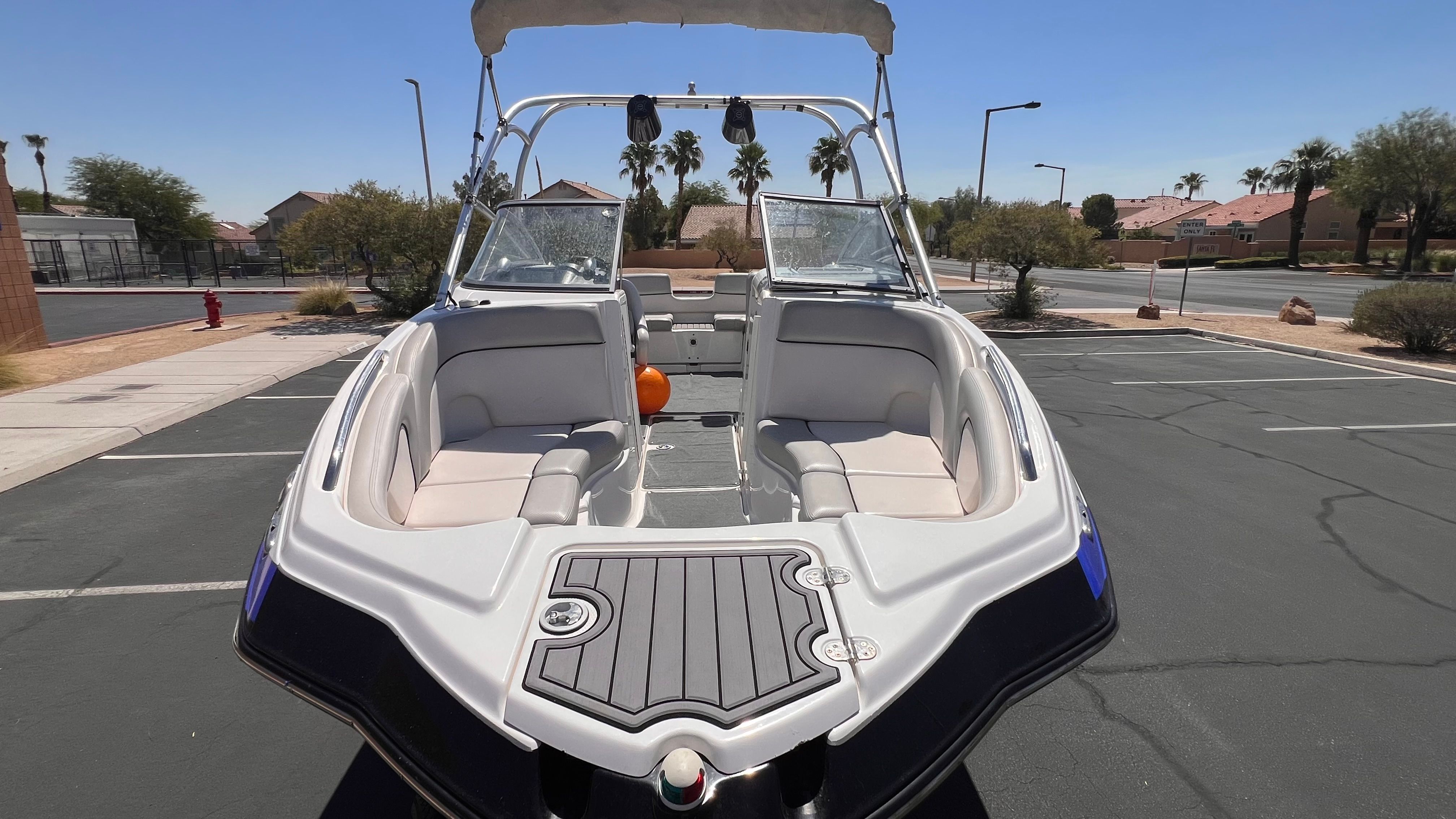 2011 Yamaha AR240 HO boat parked under sunny skies.