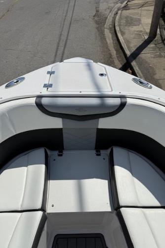 2023 Chaparral 267 SSX boat bow with seating, parked on a street.