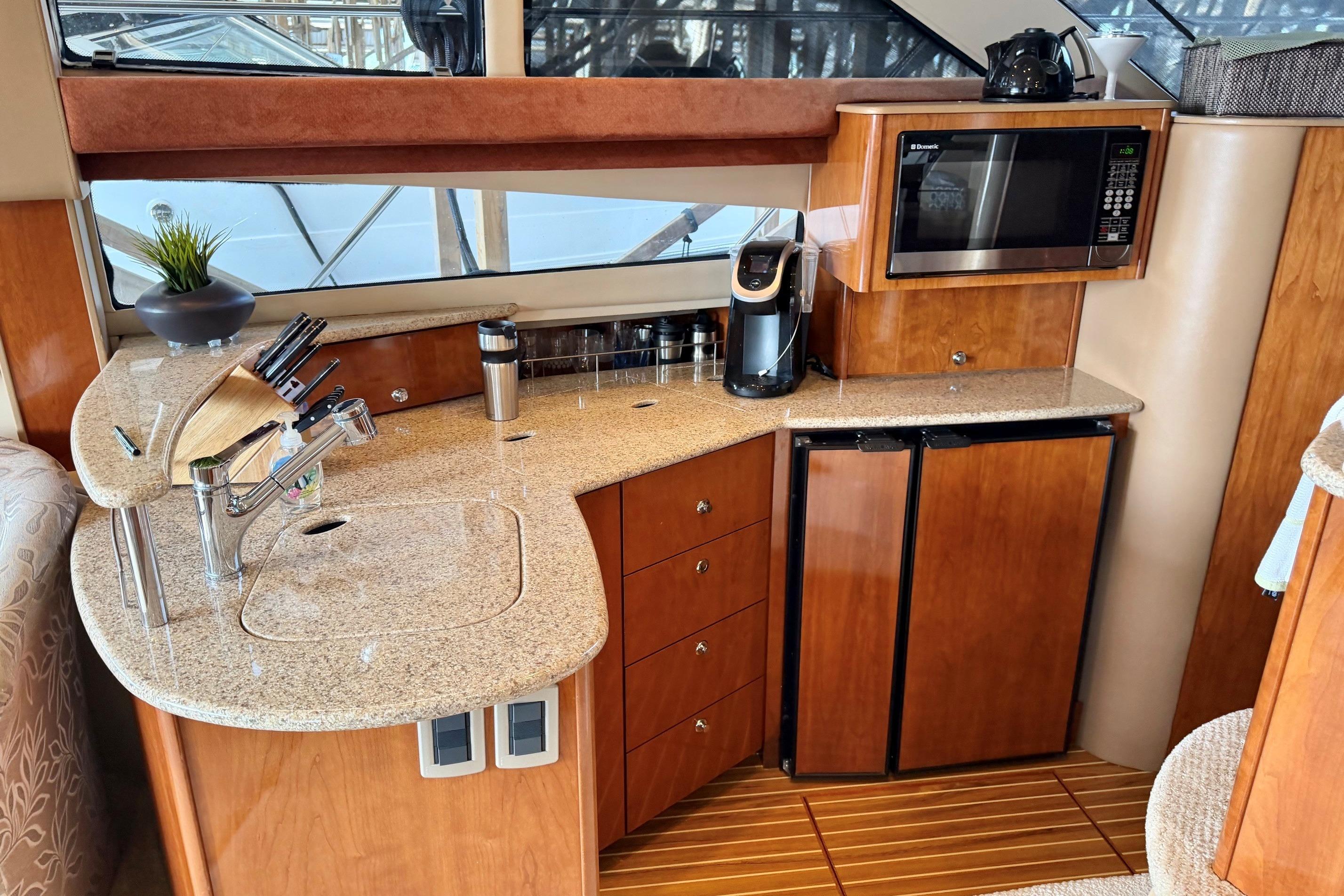 Luxurious 2007 Meridian 391 Sedan yacht kitchen with granite countertops and modern appliances.