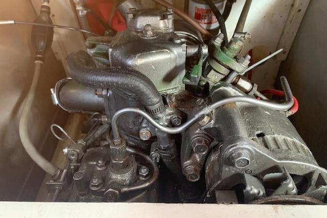 Engine of a 1980 Beneteau Half Tonner sailboat, showcasing mechanical components.