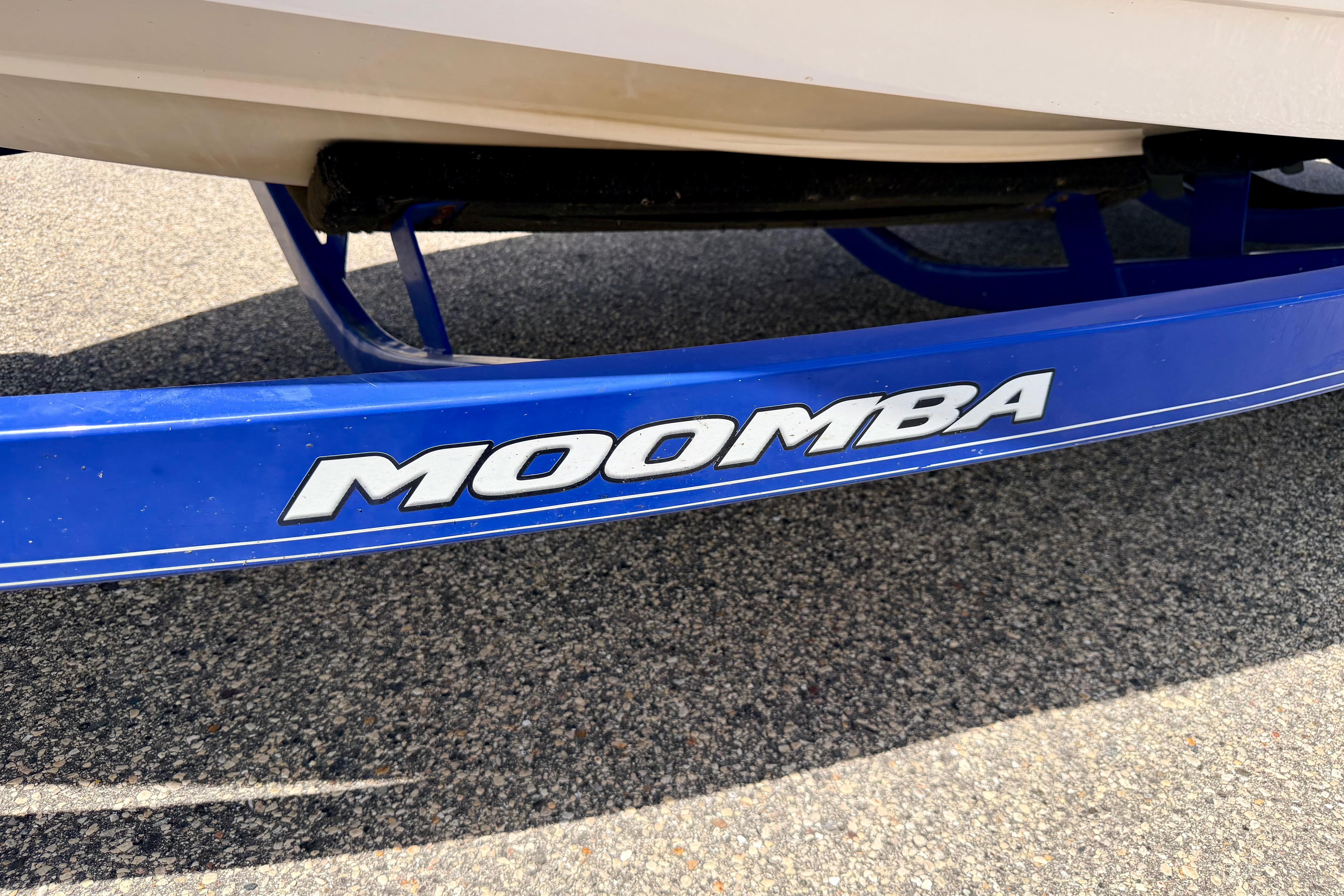 Blue Moomba Outback V 2008 boat trailer on pavement.