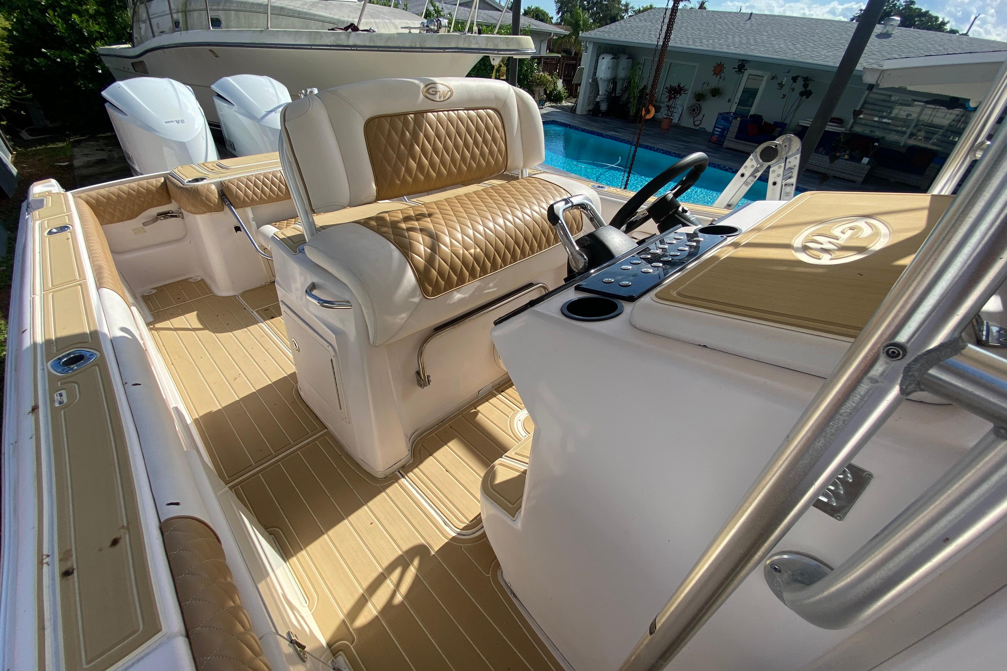 2004 Grady-White Canyon 283 boat interior with tan and white seating, near a pool.