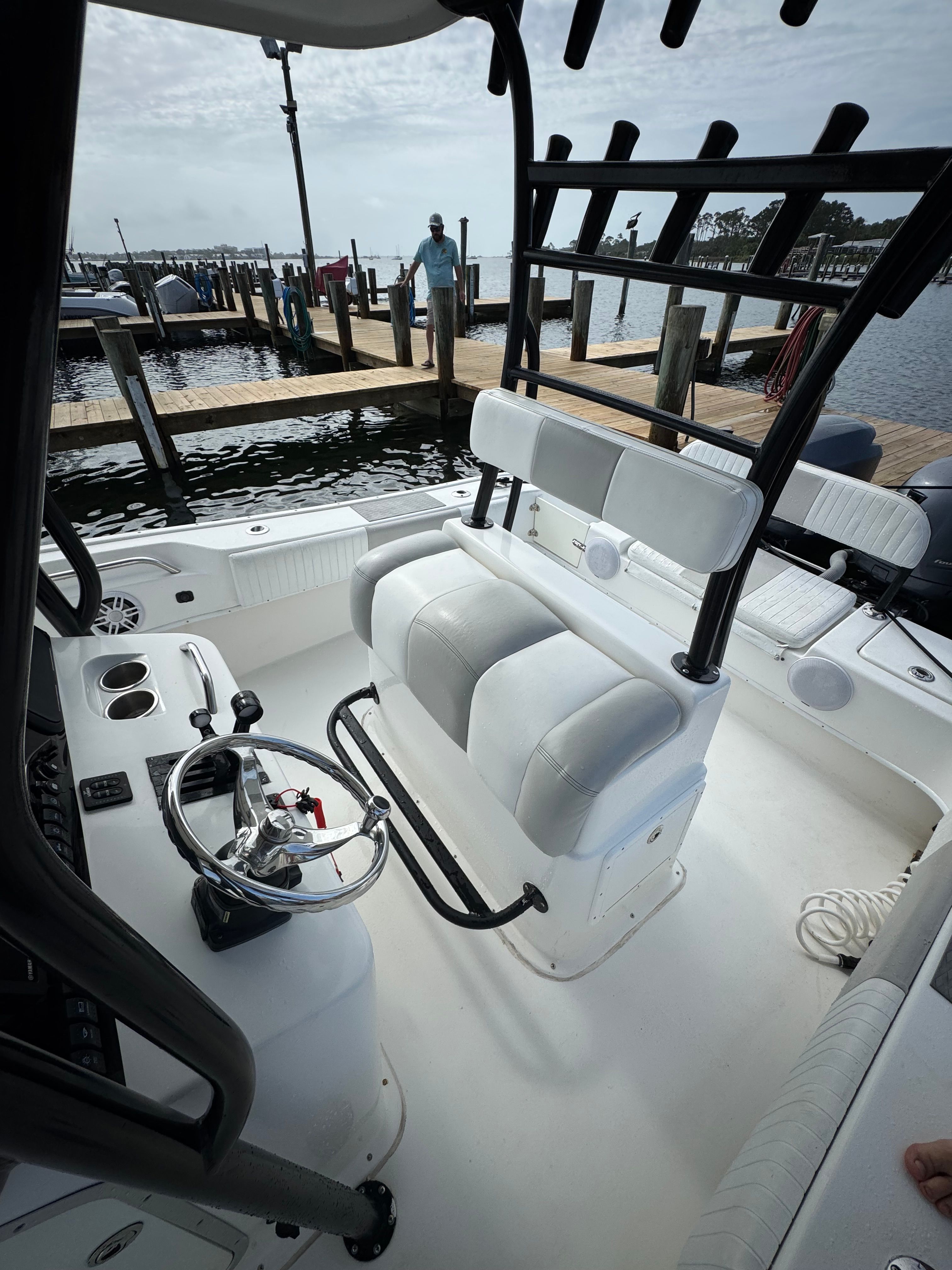 The image shows the cockpit of a 2014 Cape Horn 24XS boat at a dock.