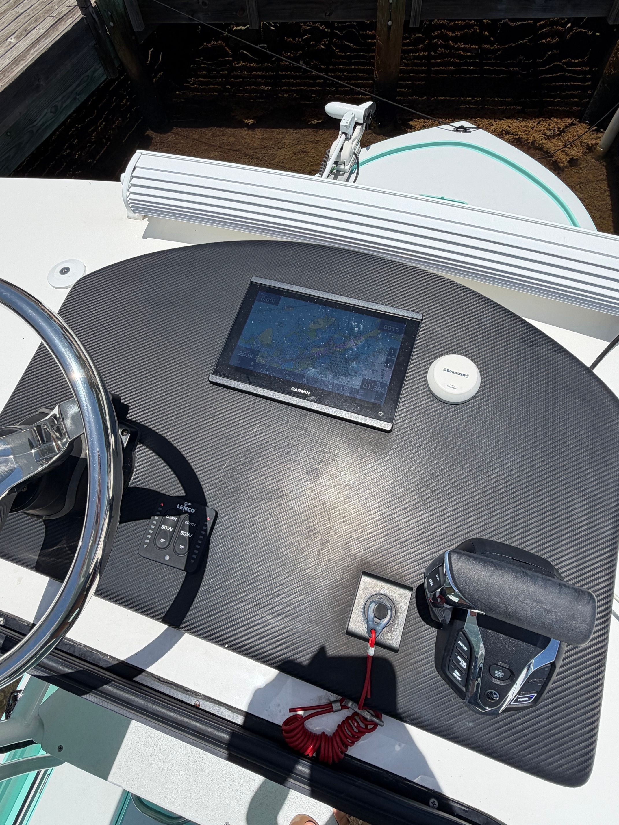 The dashboard of a boat with a screen and controls.