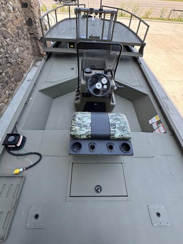 2025 Tracker Grizzly 2072 CC Sportsman boat interior with steering console and seating.