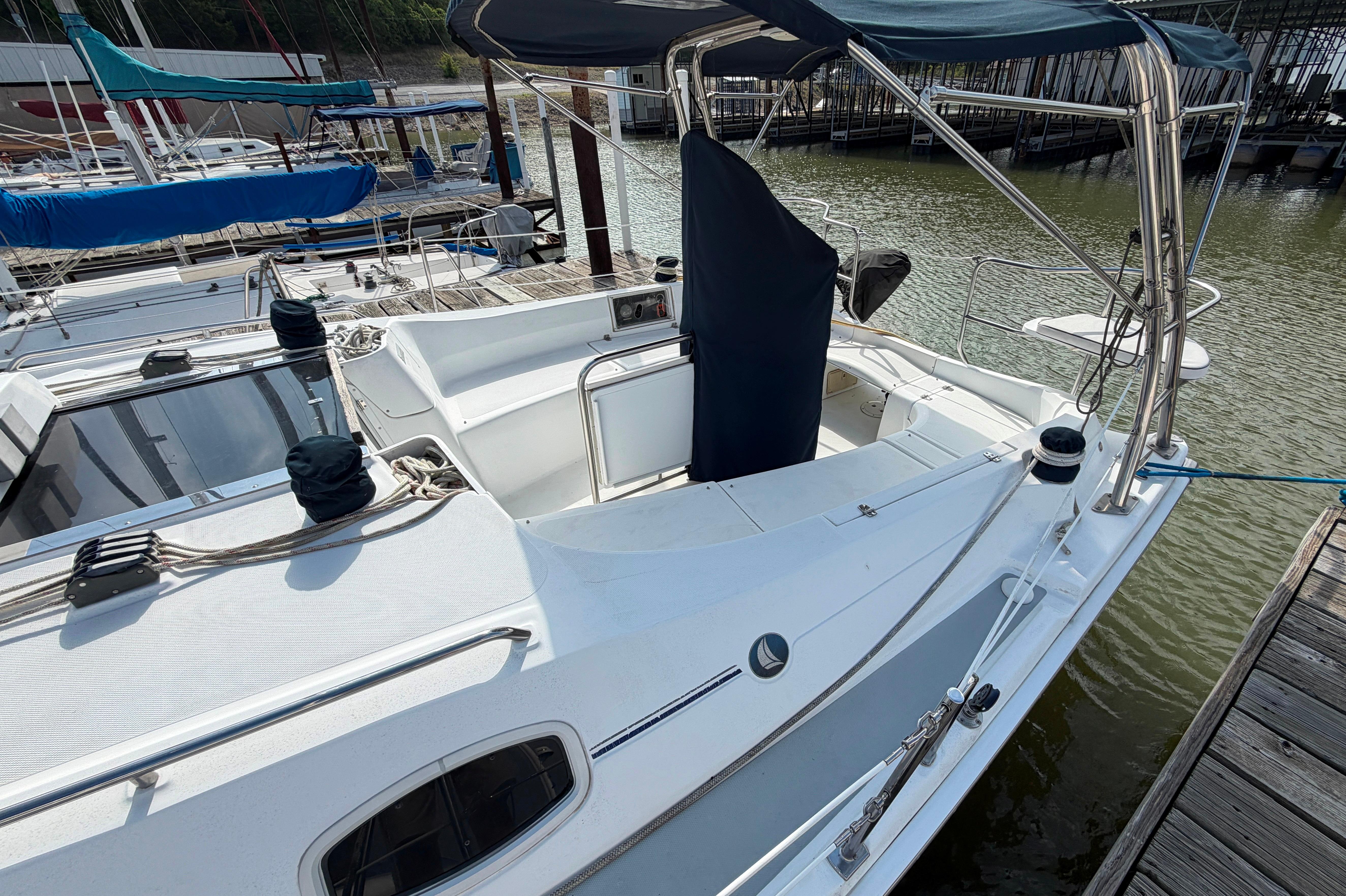 2008 Hunter 36 sailboat docked at marina, featuring spacious cockpit and covered helm.