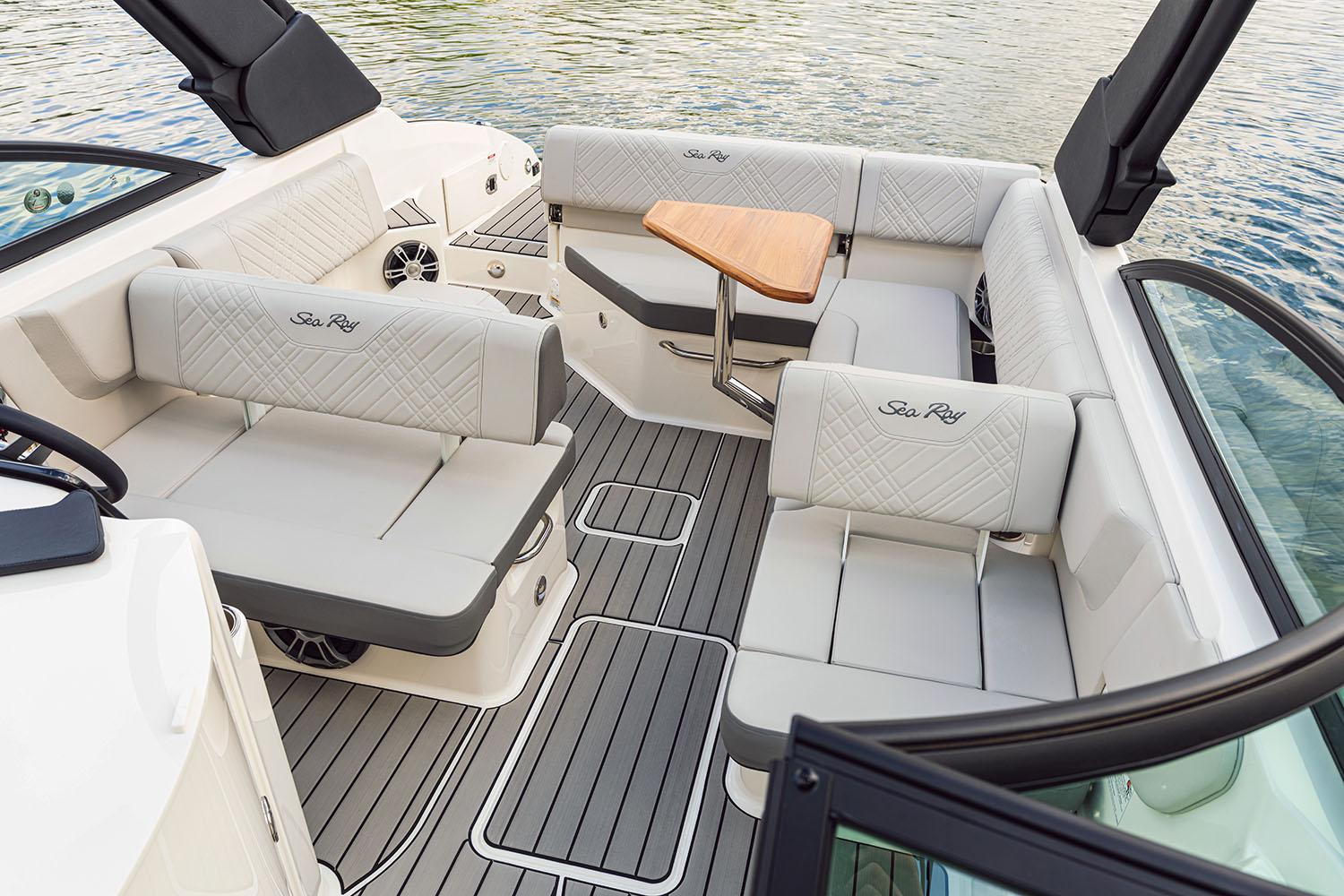 Manufacturer Provided Image: 2025 Sea Ray SDX 250 boat interior with luxurious seating and wooden table.