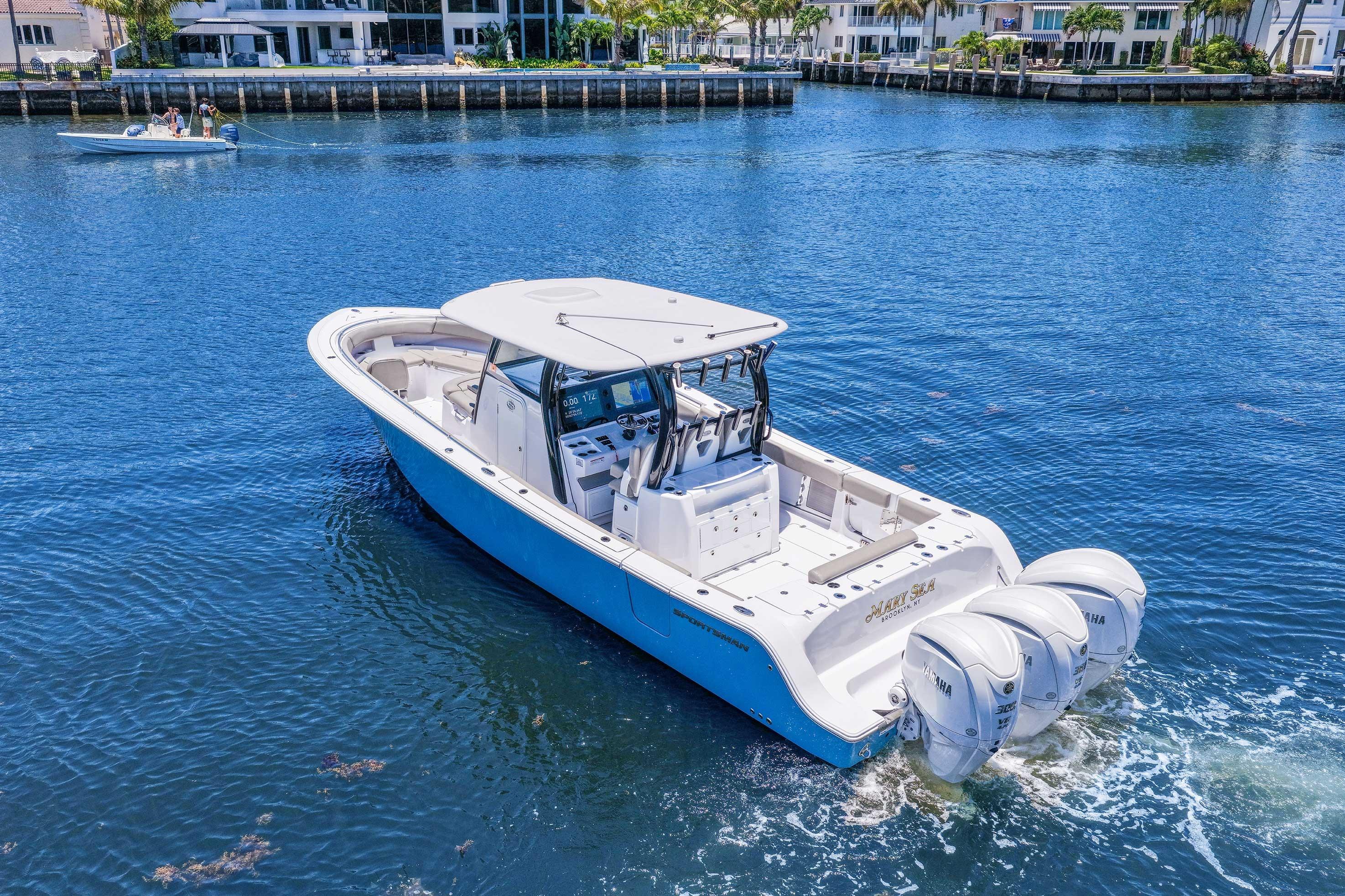 2024 Sportsman Open 352 Center Console boat cruising on a sunny waterfront.