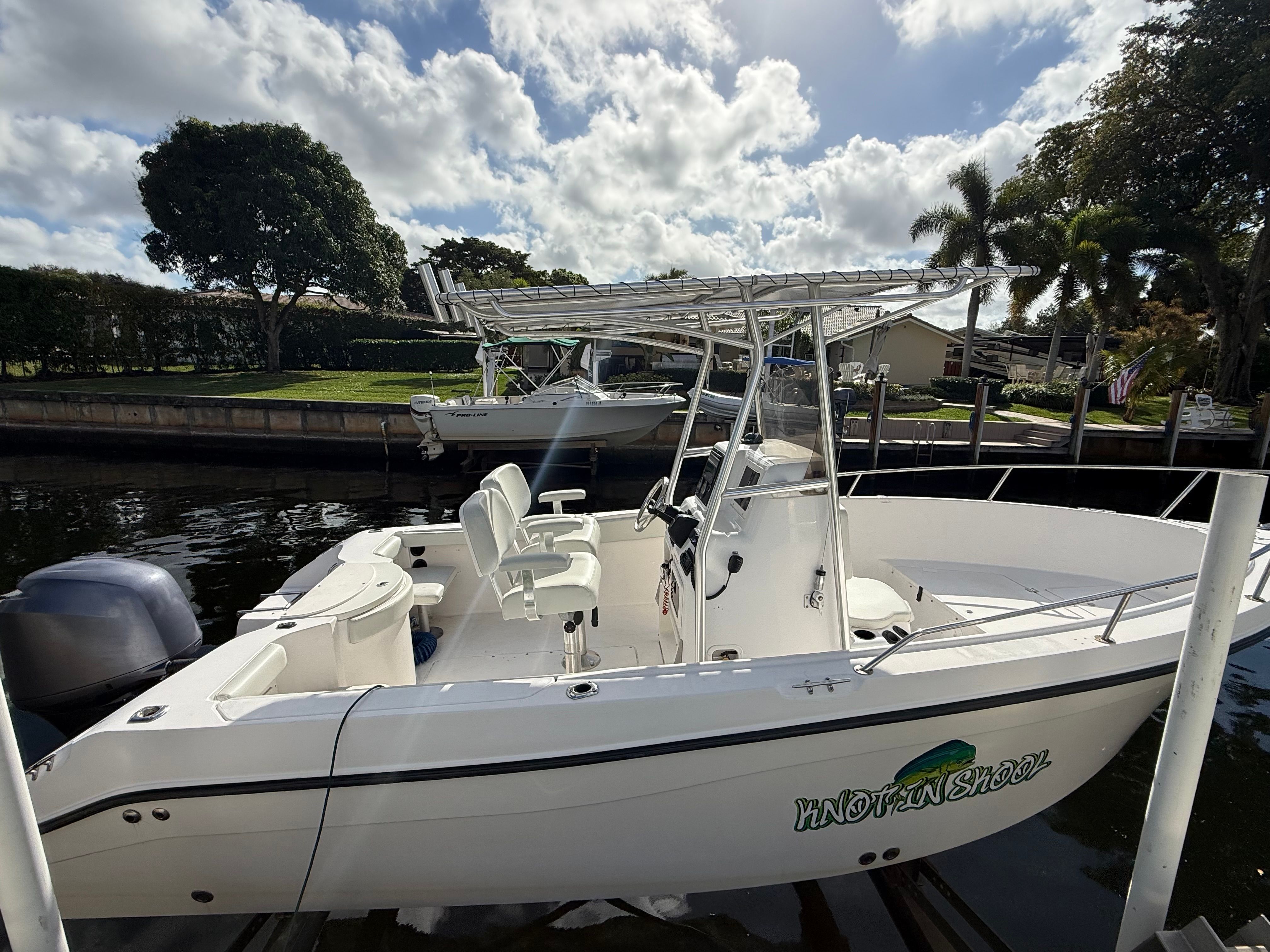 2006 Seaswirl Striper Center Console boat at dock.