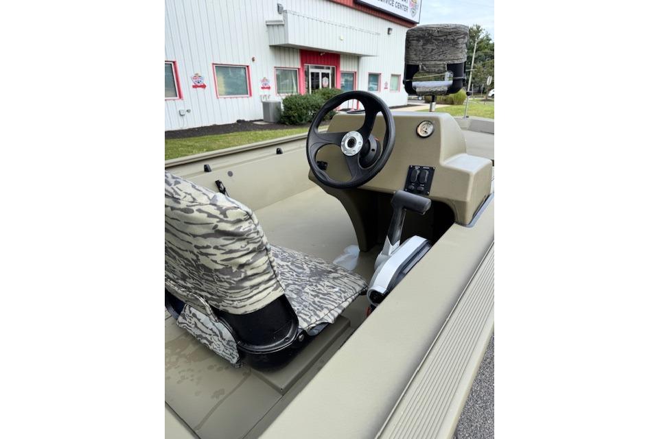 2026 Tracker Grizzly 1754 SC boat interior with camo seats and steering wheel.