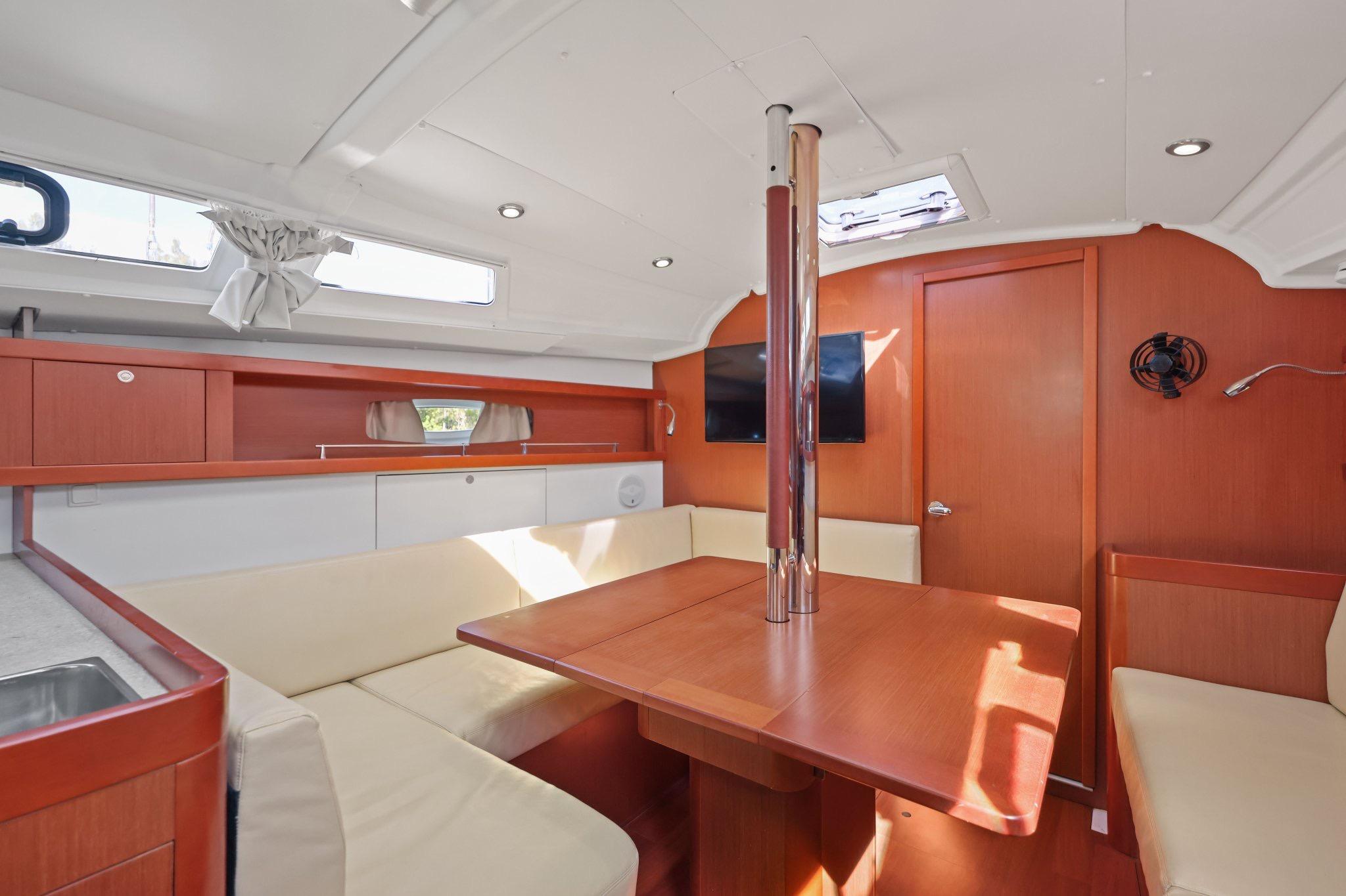 Interior of 2014 Beneteau Oceanis 37 sailboat with modern seating and wooden finishes.